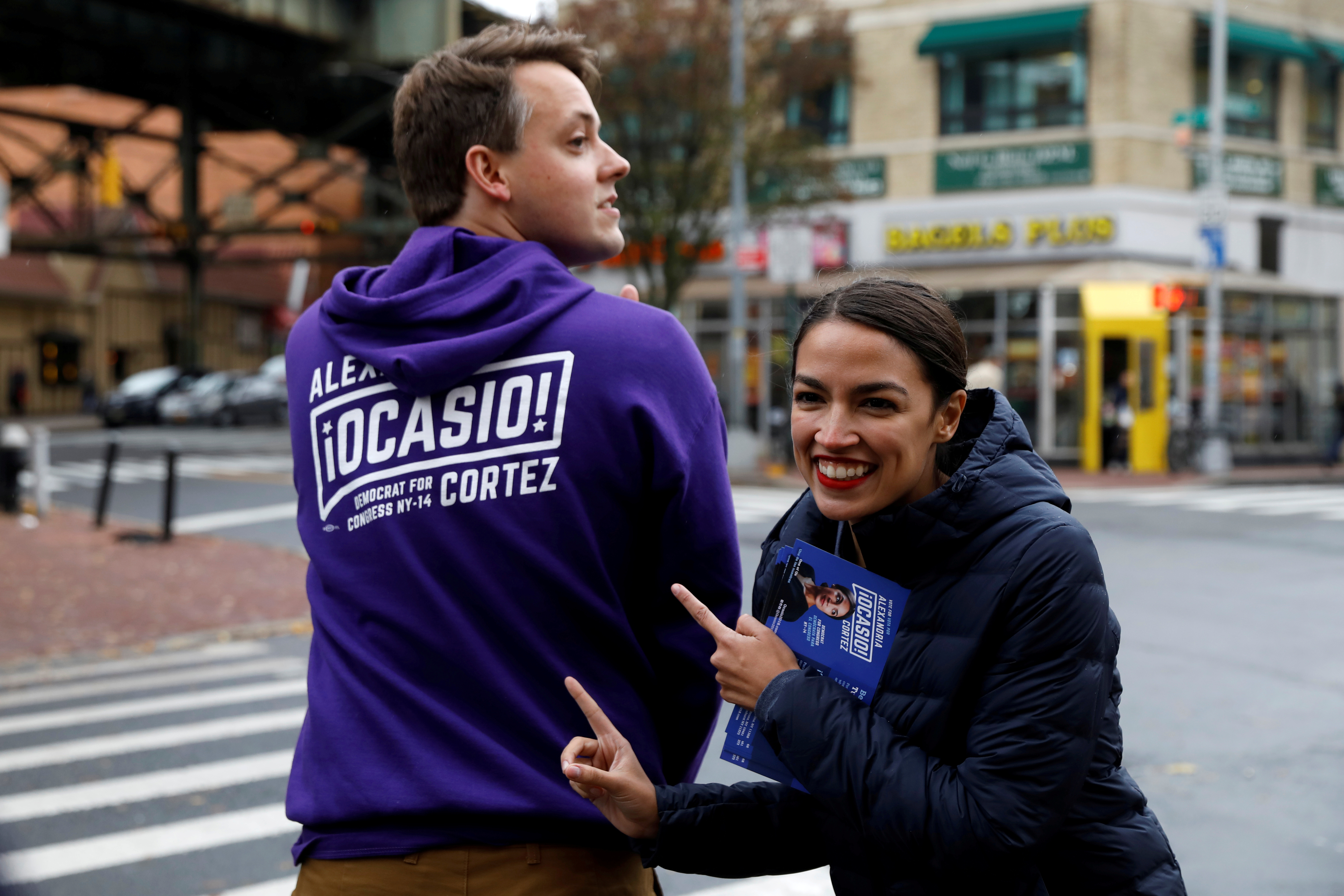 Democratic Congressional candidate Alexandria Ocasio-Cortez poses with a campaign worker during a whistle stop in the Queens borough of New York City