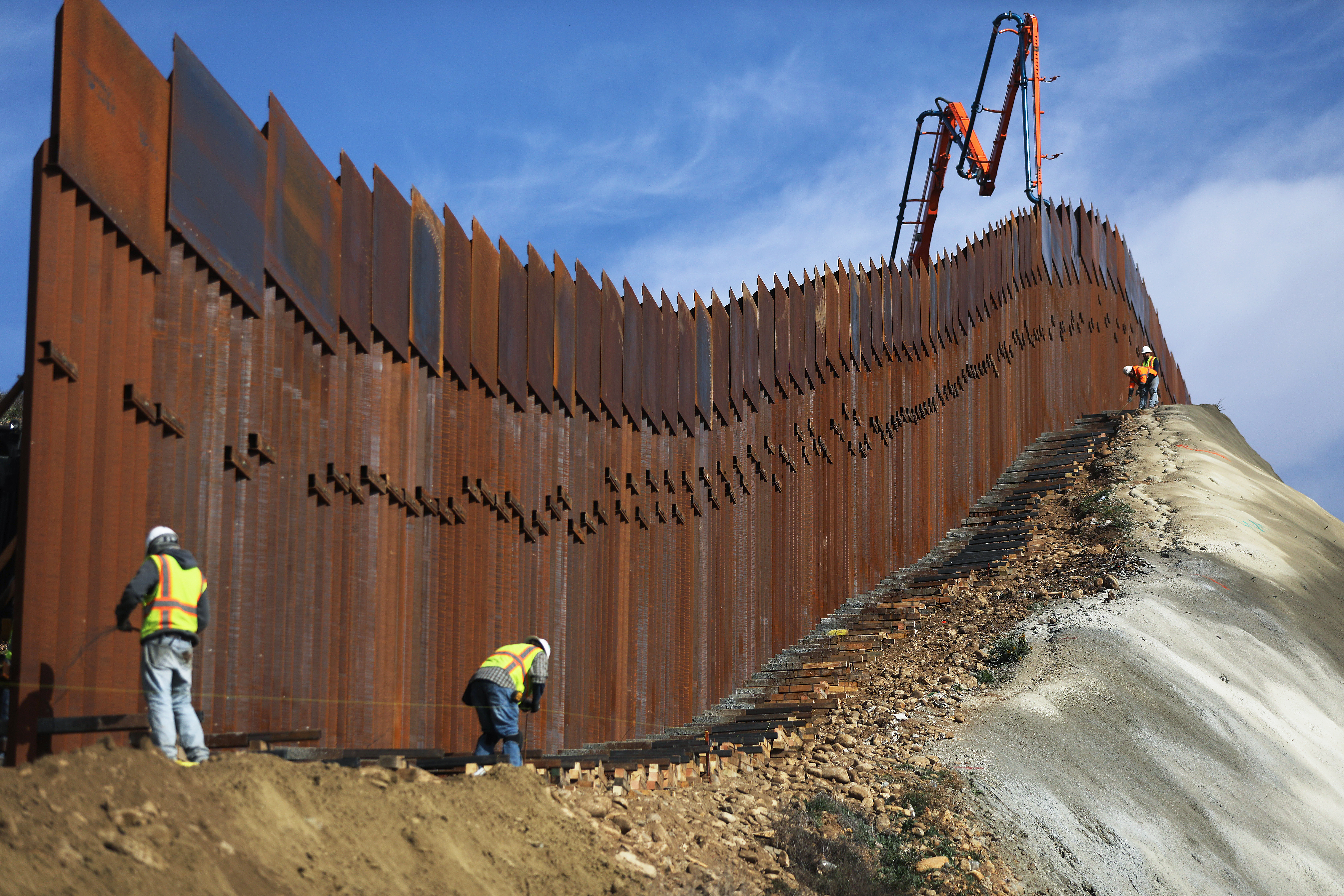 A construction crew works as new sections of the U.S.-Mexico border barrier are installed on January 11, 2019. (Mario Tama/Getty Images)