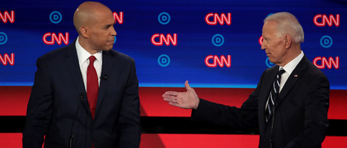 DETROIT, MICHIGAN - JULY 31: Democratic presidential candidate Sen. Cory Booker (D-NJ) (L) and former Vice President Joe Biden during the Democratic Presidential Debate at the Fox Theatre July 31, 2019 in Detroit, Michigan. 20 Democratic presidential candidates were split into two groups of 10 to take part in the debate sponsored by CNN held over two nights at Detroit?s Fox Theatre. (Photo by Scott Olson/Getty Images)