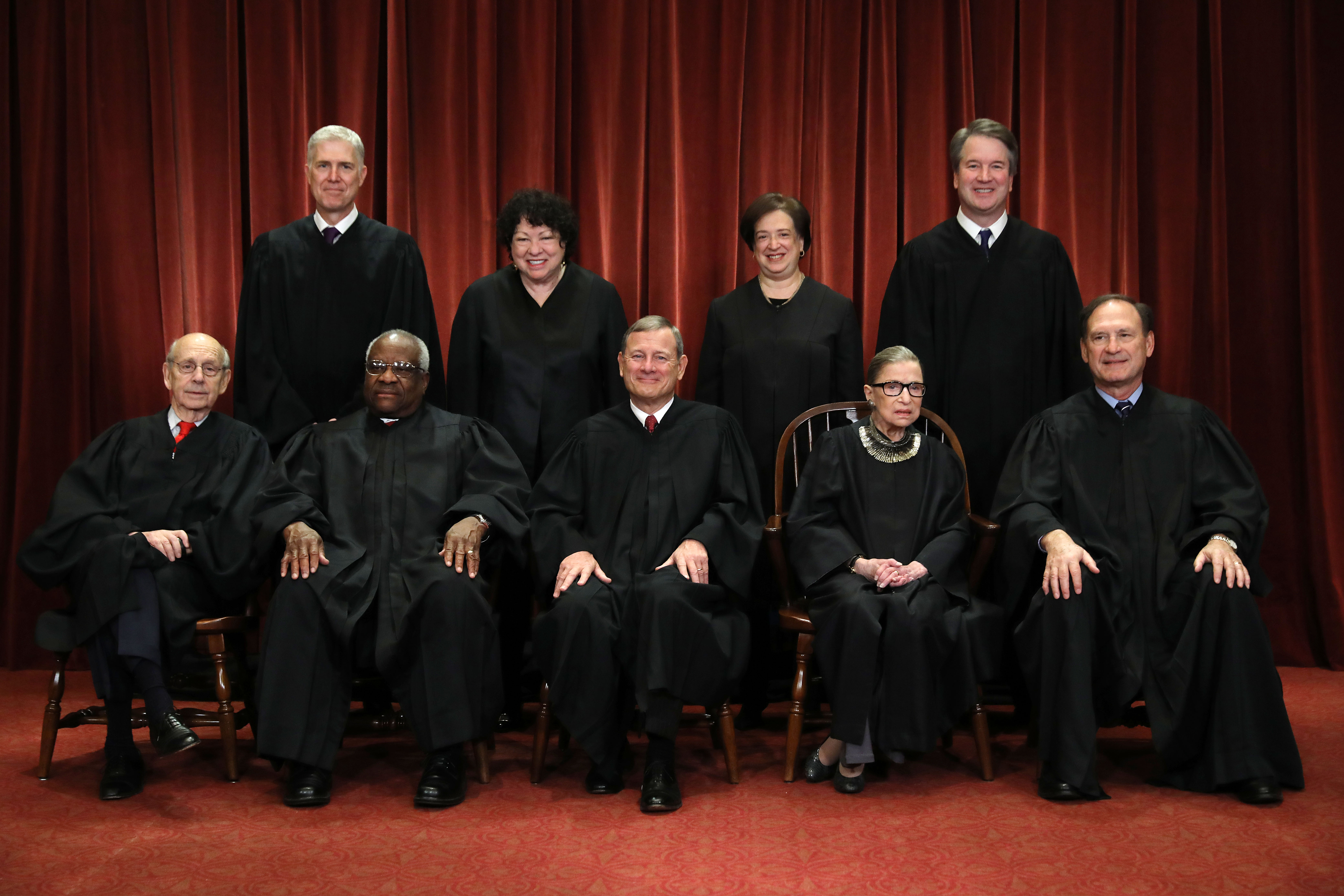 United States Supreme Court (Front L-R) Associate Justice Stephen Breyer, Associate Justice Clarence Thomas, Chief Justice John Roberts, Associate Justice Ruth Bader Ginsburg, Associate Justice Samuel Alito, Jr., (Back L-R) Associate Justice Neil Gorsuch, Associate Justice Sonia Sotomayor, Associate Justice Elena Kagan and Associate Justice Brett Kavanaugh pose for their official portrait at the in the East Conference Room at the Supreme Court building November 30, 2018 in Washington, DC. Earlier this month, Chief Justice Roberts publicly defended the independence and integrity of the federal judiciary against President Trump after he called a judge who had ruled against his administration’s asylum policy “an Obama judge.” “We do not have Obama judges or Trump judges, Bush judges or Clinton judges,” Roberts said in a statement. “What we have is an extraordinary group of dedicated judges doing their level best to do equal right to those appearing before them. That independent judiciary is something we should all be thankful for.” (Photo by Chip Somodevilla/Getty Images)
