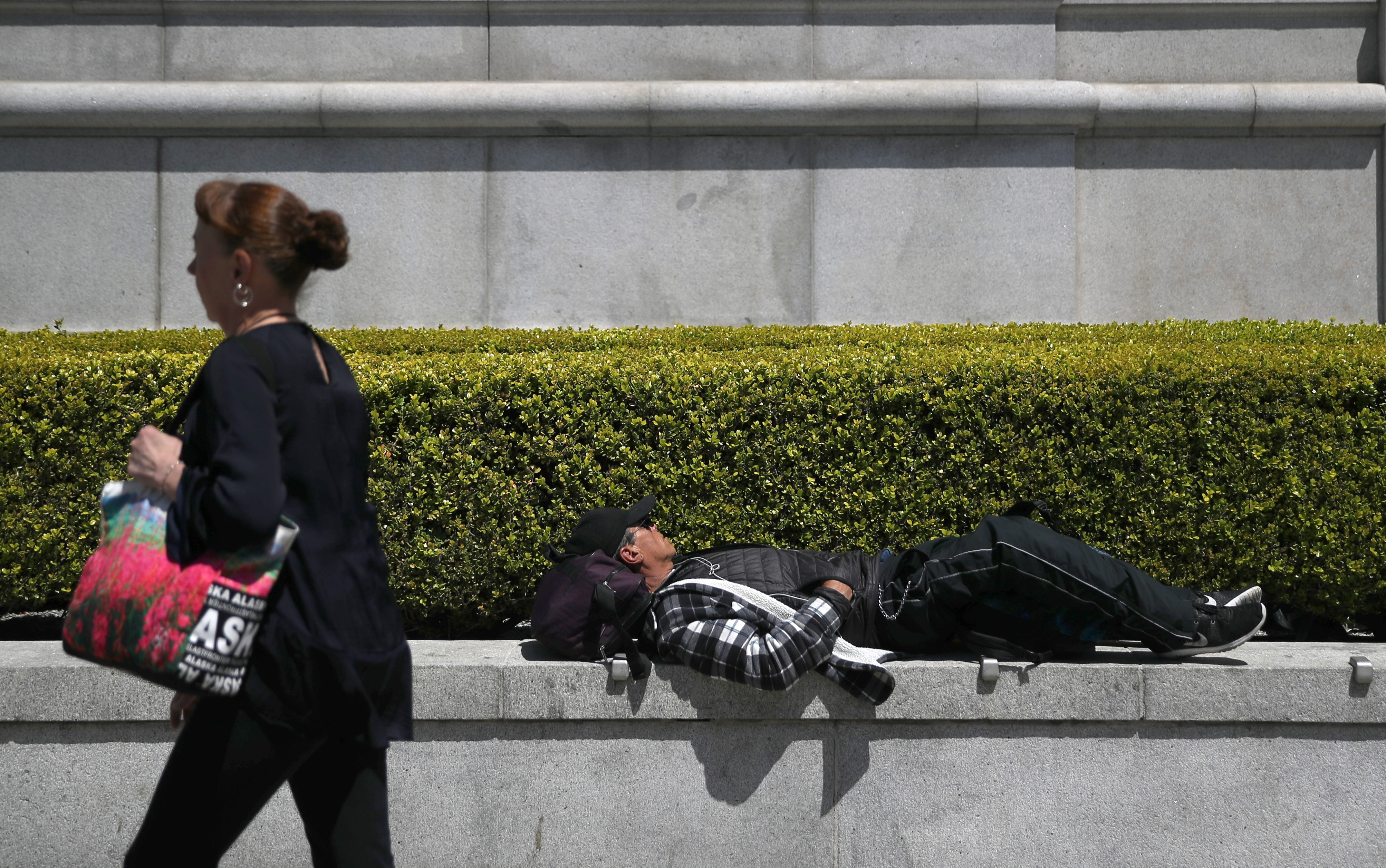 Homeless Man Sleeping Outside Asian Art Museum (Photo by Justin Sullivan/Getty Images)