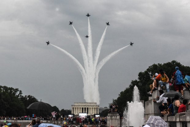 WASHINGTON, DC - JULY 04: People react to a military fly over on the National Mall while President Donald Trump gives his speech during Fourth of July festivities on July 4, 2019 in Washington, DC. President Trump is holding a "Salute to America" celebration on the National Mall on Independence Day this year with musical performances, a military flyover, and fireworks. (Photo by Stephanie Keith/Getty Images)