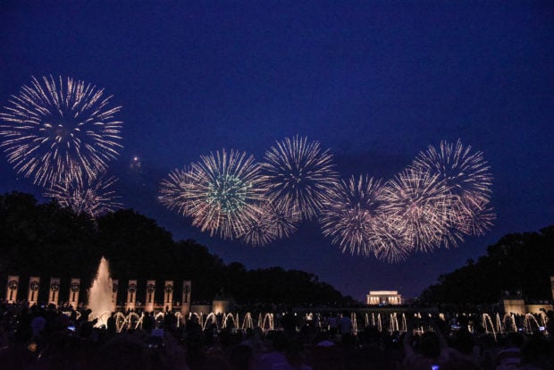 WASHINGTON, DC - JULY 04: People watch the fireworks display on the National Mall during Fourth of July festivities on July 4, 2019 in Washington, DC. President Trump is holding a "Salute to America" celebration on the National Mall on Independence Day this year with musical performances, a military flyover, and fireworks. (Photo by Stephanie Keith/Getty Images)