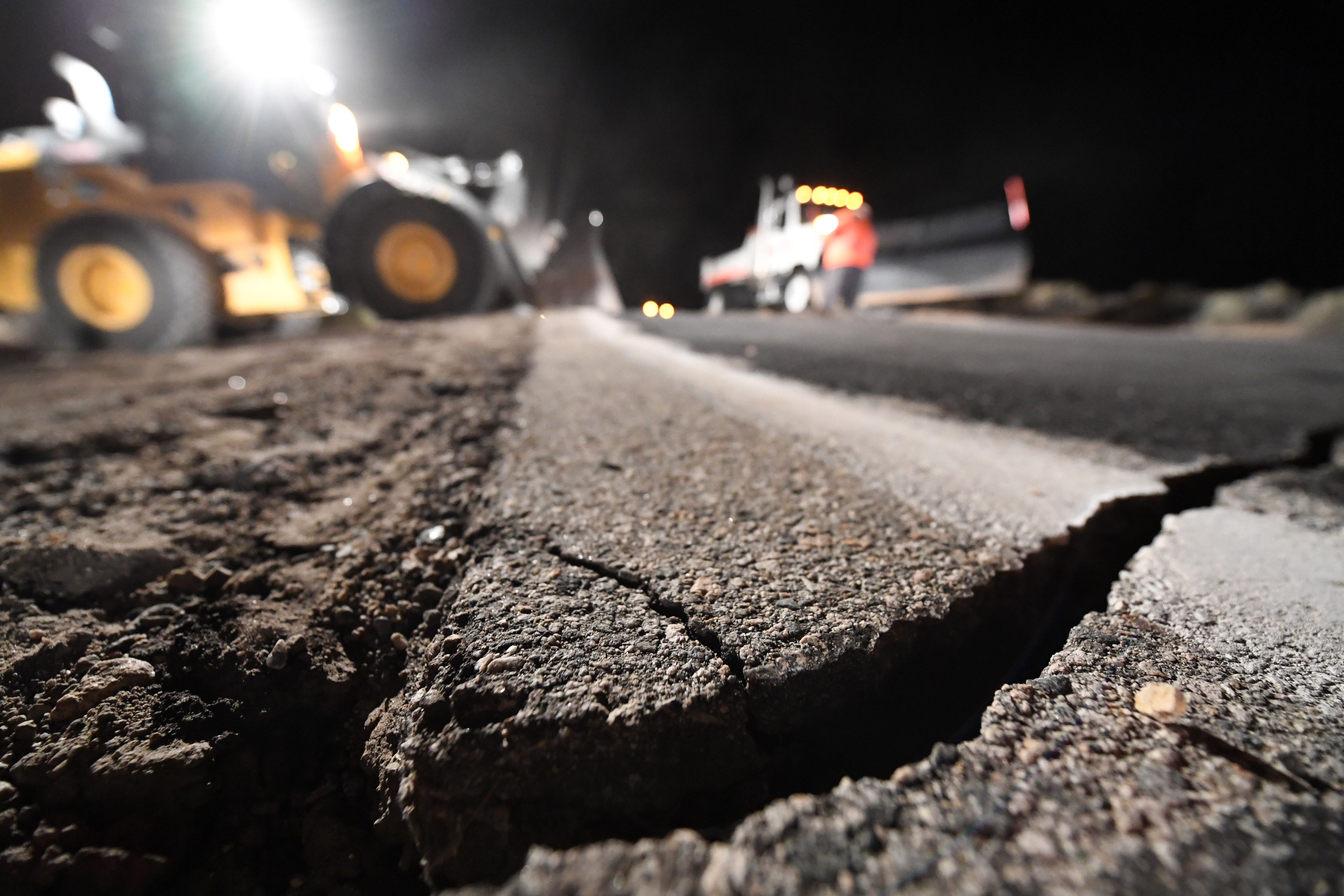 Highway workers repair a hole that opened in the road as a result of the July 5, 2019 earthquake, in Ridgecrest, California, about 150 miles (241km) north of Los Angeles, early in the morning on July 6, 2019. - Southern California was hit by its largest earthquake in two decades on July 5, a 7.1-magnitude tremor that rattled residents who were already reeling from another strong quake a day earlier. (Photo by Robyn Beck / AFP) (Photo credit should read ROBYN BECK/AFP/Getty Images)
