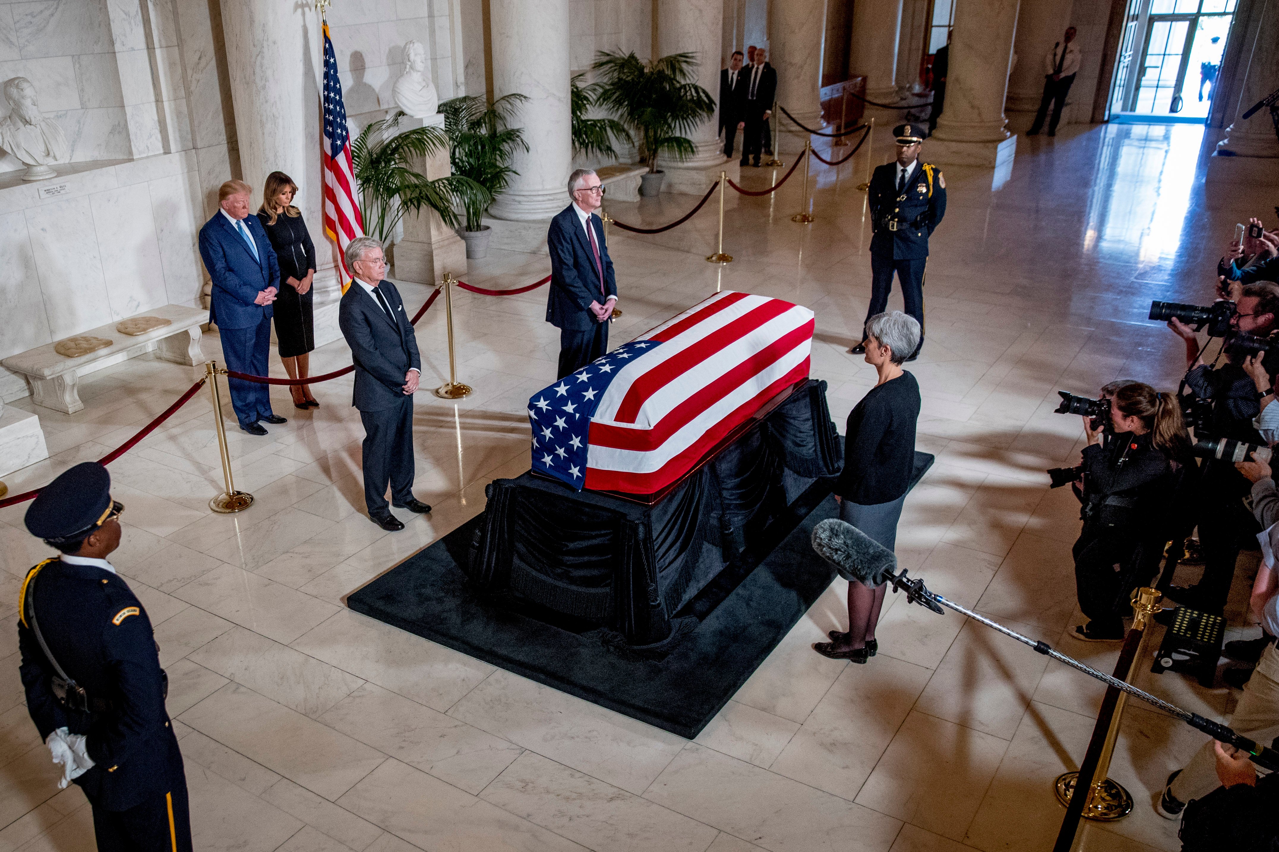 President Donald Trump and first lady Melania Trump pay their respects as the late Justice John Paul Stevens lies in repose in the great hall of the Supreme Court. (Andrew Harnik/AFP/Getty Images)