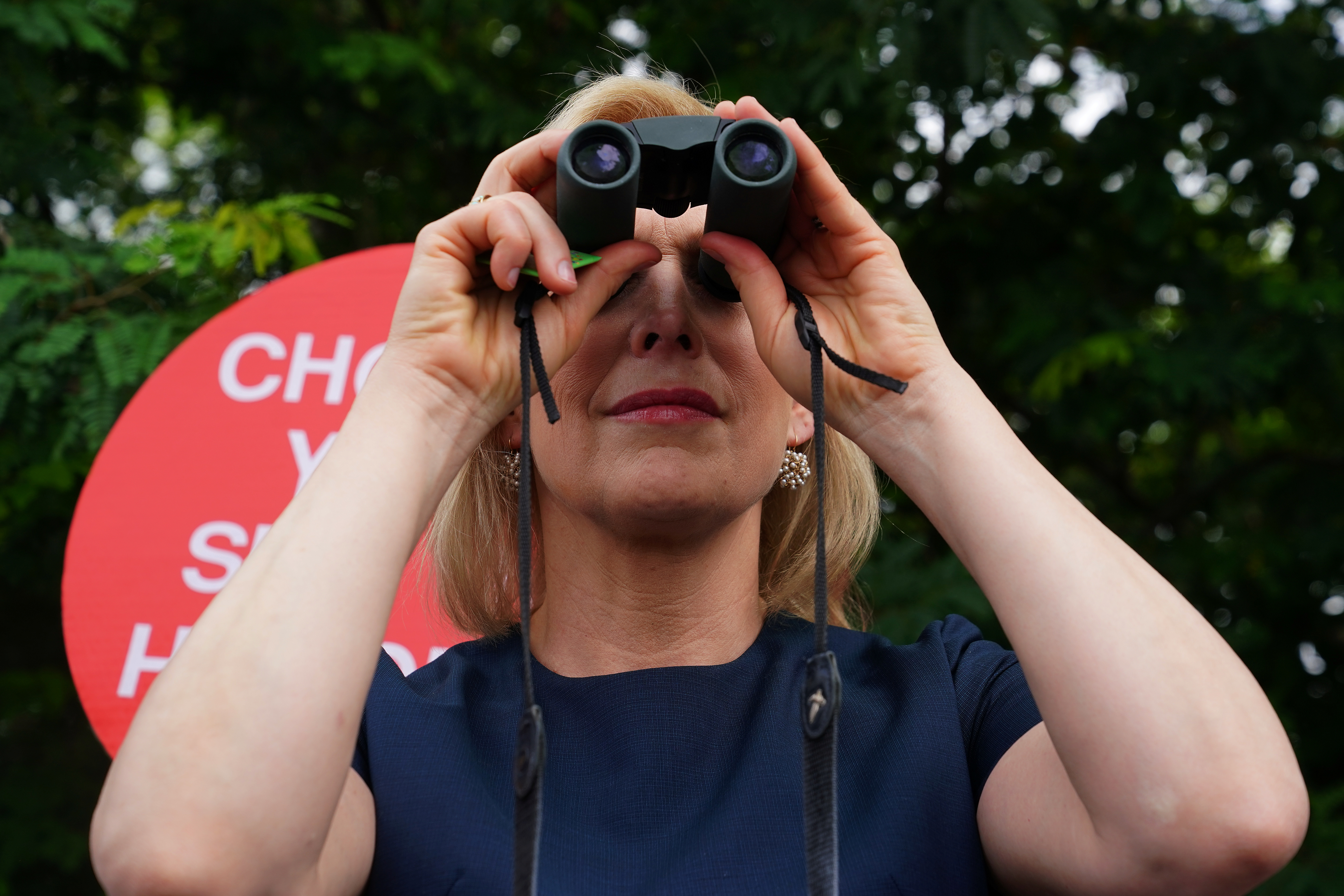 United States Senator Kirsten Gillibrand uses binoculars to look at youths incarcerated at a dentition facility near Miami in Homestead, Florida, U.S., June 28, 2019. REUTERS/Carlo Allegri
