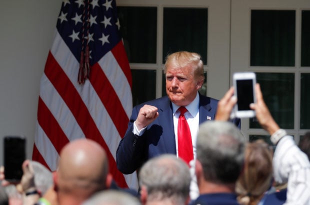 U.S. President Donald Trump pumps his fist during a signing ceremony for the "Permanent Authorization of the September 11th Victim Compensation Fund Act" in the Rose Garden of the White House in Washington, U.S., July 29, 2019. (REUTERS/Carlos Barria)