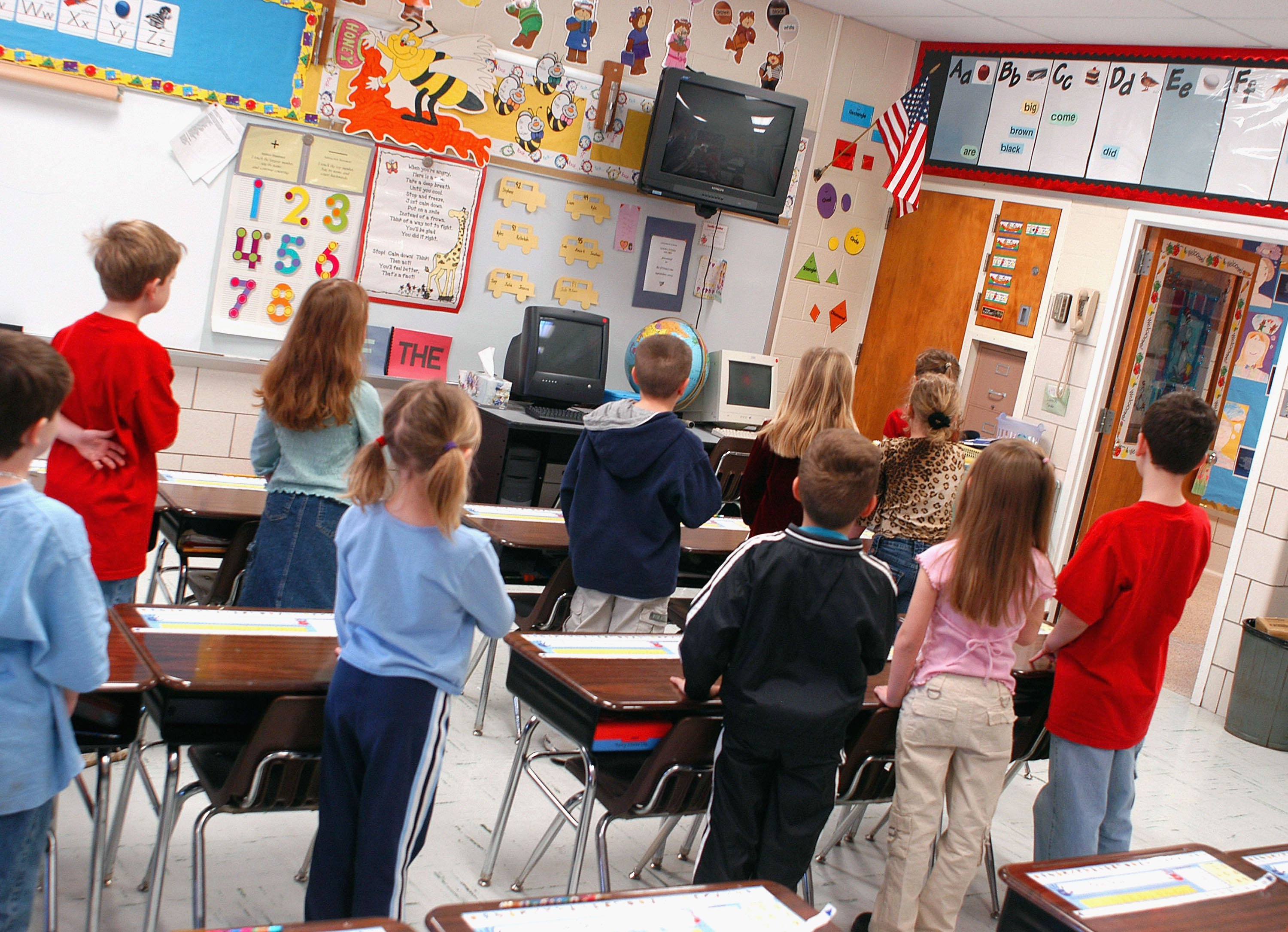 WARMINSTER, PA - MARCH 24: First graders at Longstreth Elementary School pledge allegiance to the flag March 24, 2004 in Warminster, Pennsylvania. An atheist parent, Michael Newdow, of Sacramento, California is scheduled to be heard by the Supreme Court today to defend his position that the "Under God" in the Pledge of Allegiance is unconstitutional. If the Supreme Court upholds and expands their original ruling, which affected western states, all U.S. children will be affected. (Photo by William Thomas Cain/Getty Images)