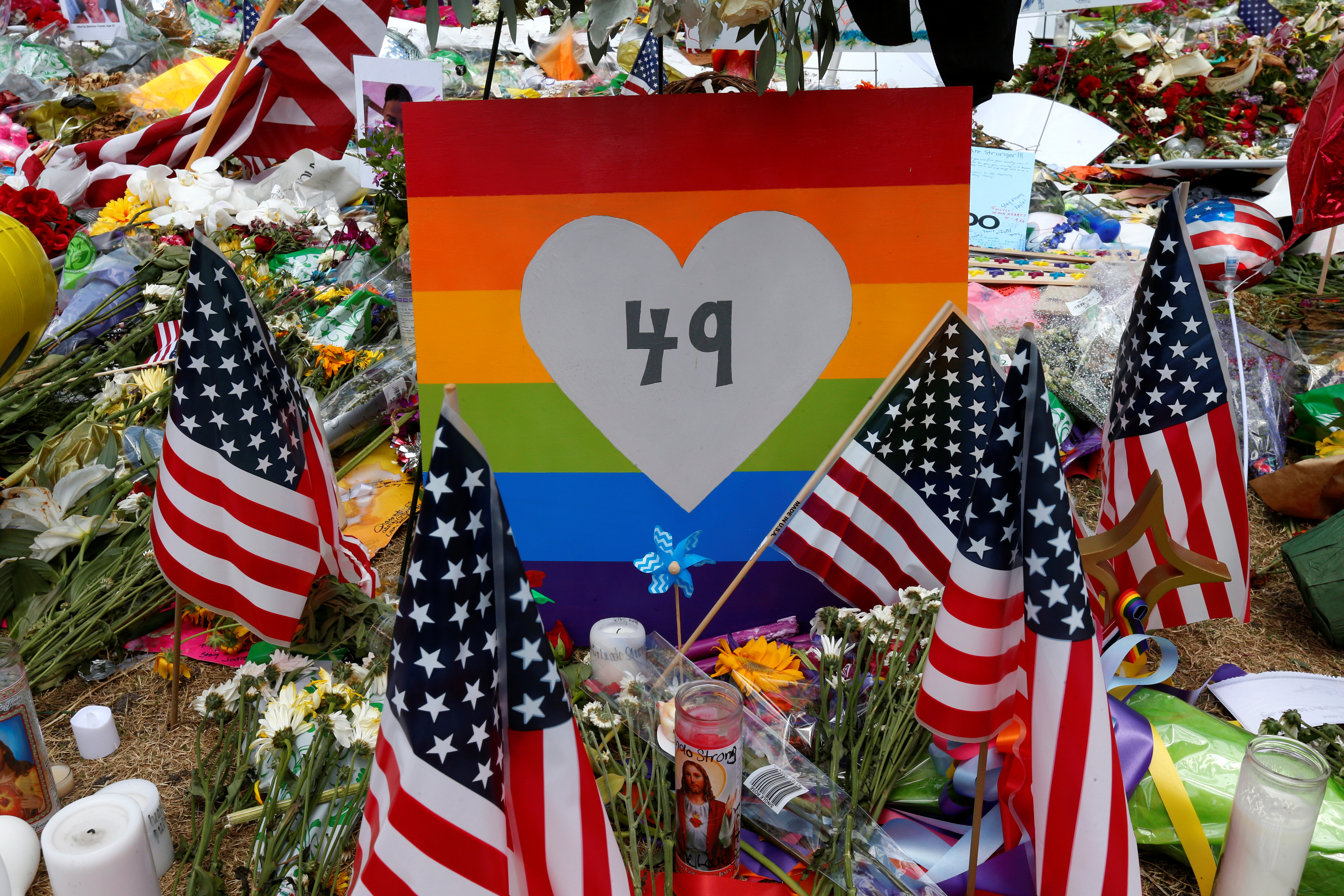 A sign with the number 49 on it is pictured as part of a makeshift memorial following the Pulse night club shootings in Orlando, Florida, U.S., June 20, 2016. REUTERS/Carlo Allegri