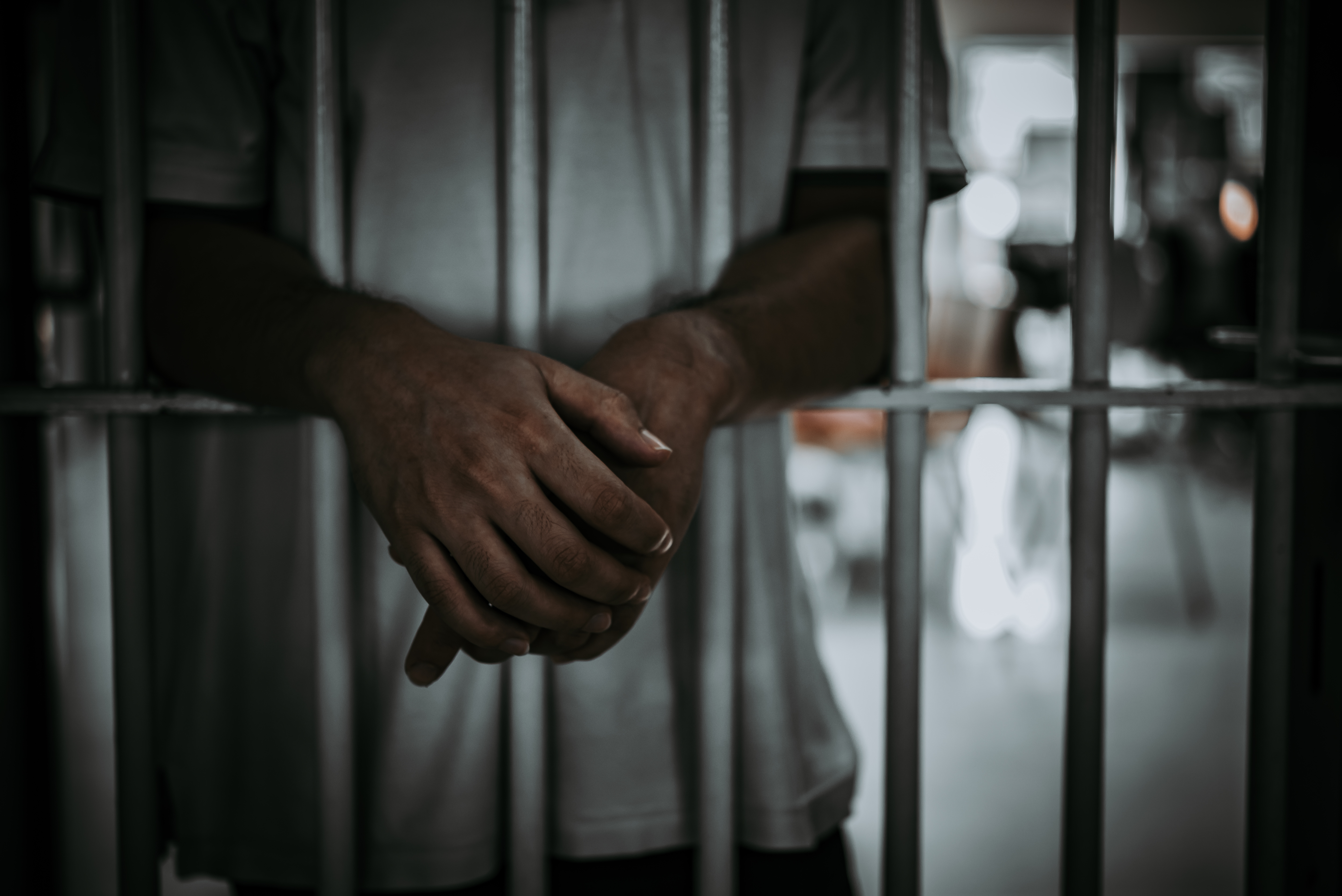 A man is in prison. Shutterstock image via kittirat roekburi