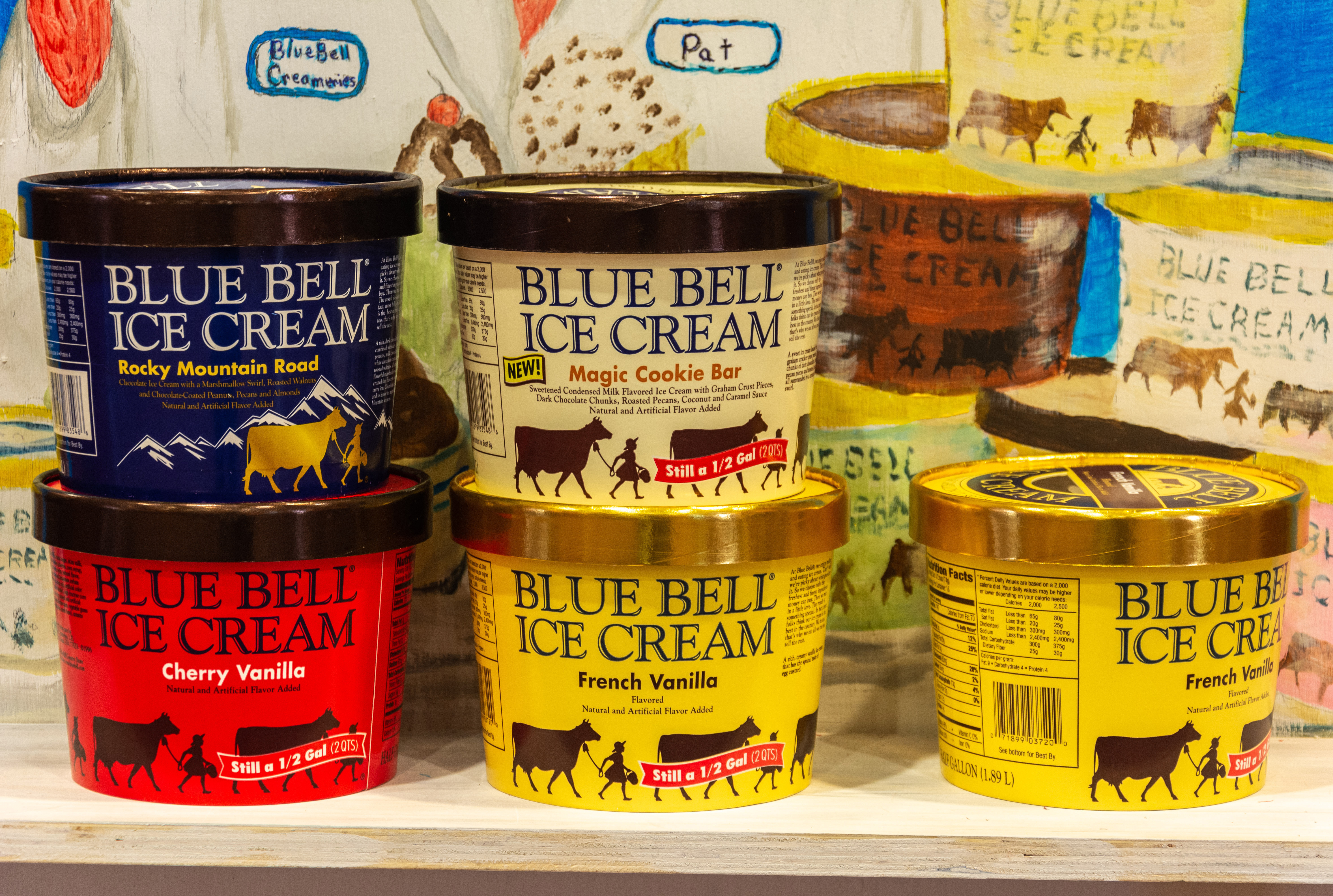 Blue Bell ice cream cartons are stacked on top of each other. Shutterstock image via Alizada Studios