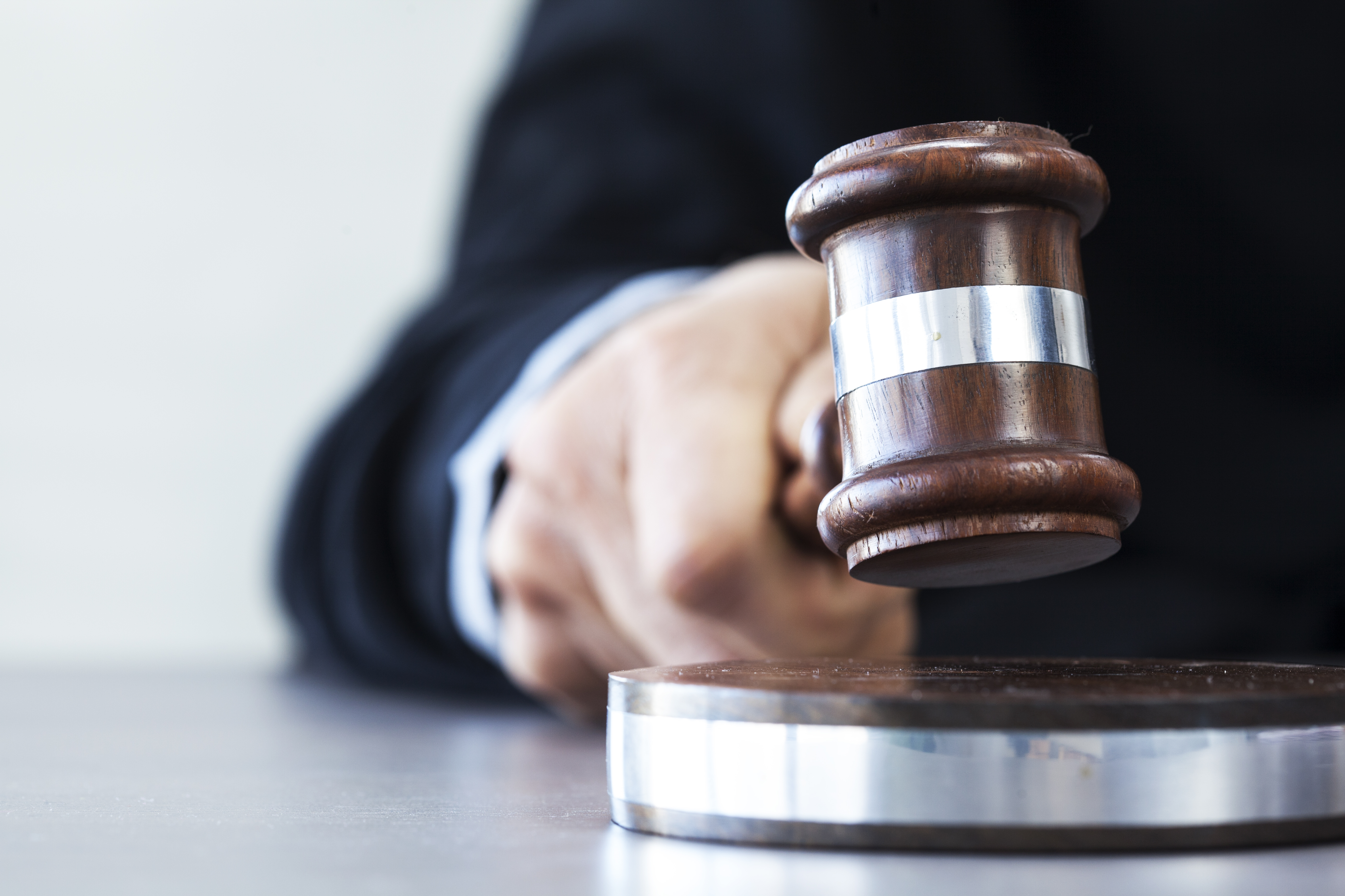 A judge bangs a gavel. Shutterstock image via sebra