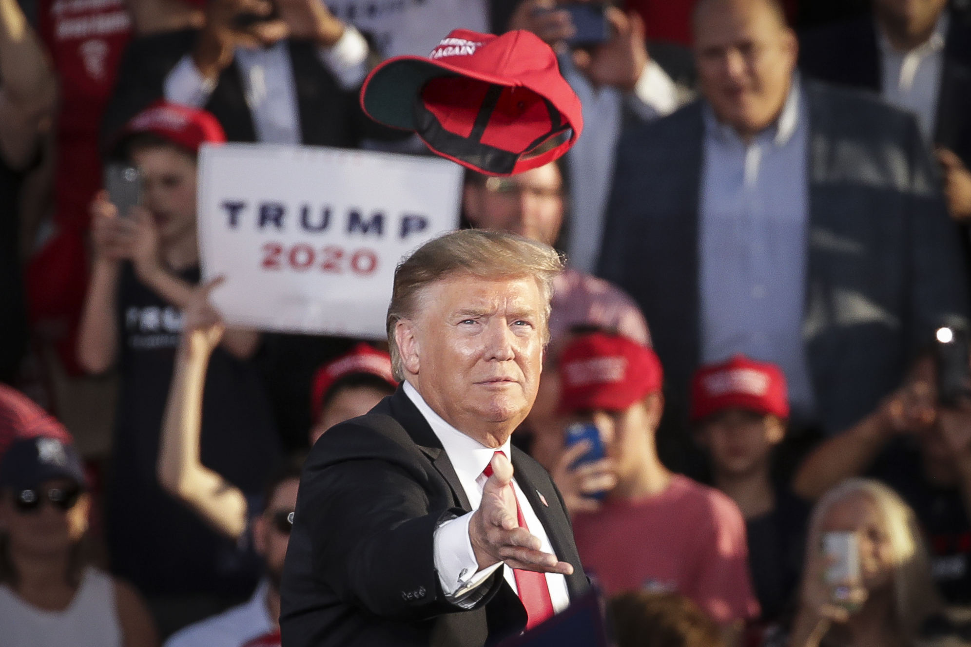 U.S. President Donald Trump tosses a hat into the crowd as he arrives for a 'Make America Great Again' campaign rally at Williamsport Regional Airport, May 20, 2019 in Montoursville, Pennsylvania. (Drew Angerer/Getty Images)