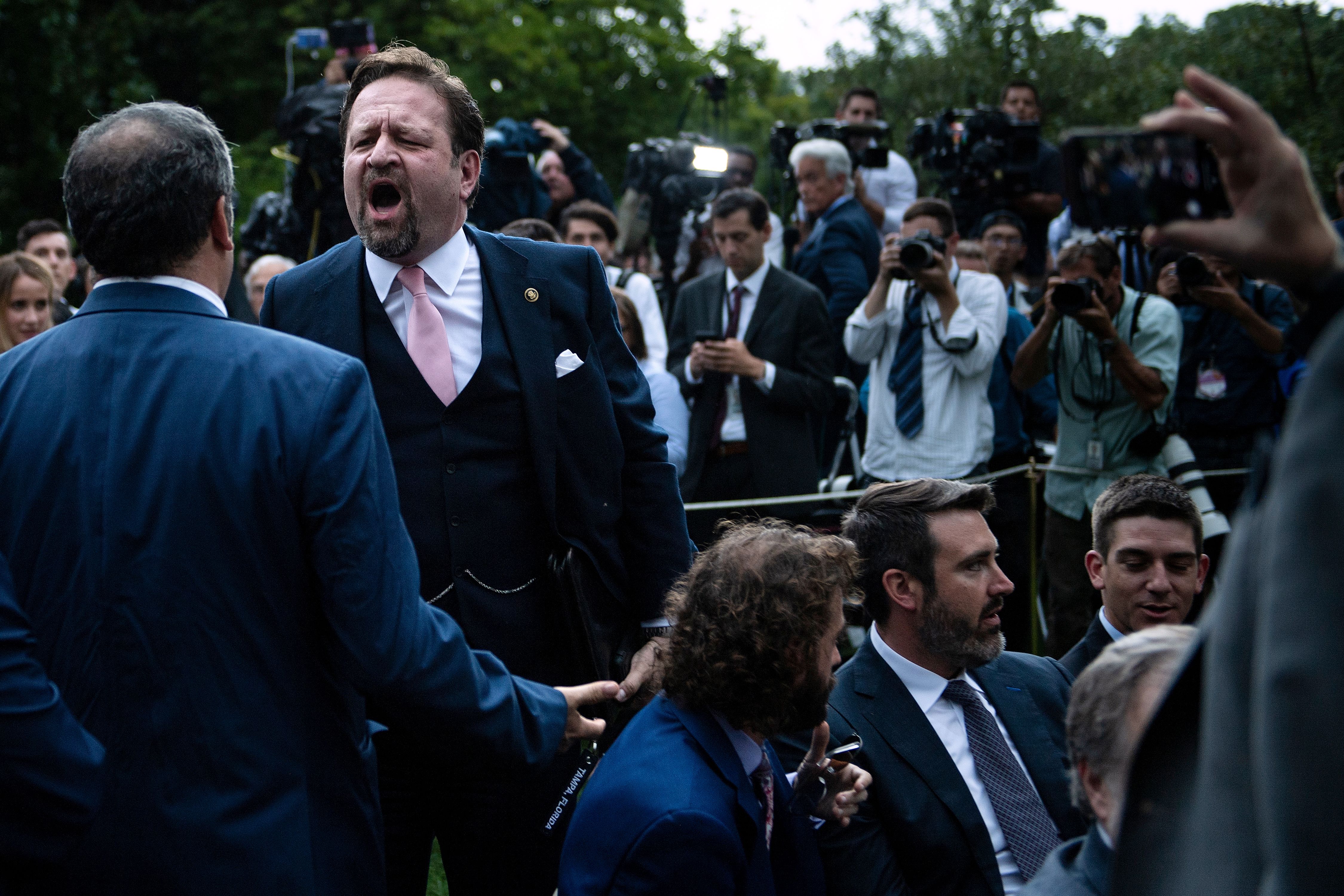 Playboy magazine contributor Brian Karem (L) and former Trump deputy assistant Sebastian Gorka (2ndL) argue after the US president delivered remarks on citizenship and the census at the White House in Washington, DC, on July 11, 2019. (BRENDAN SMIALOWSKI/AFP/Getty Images)