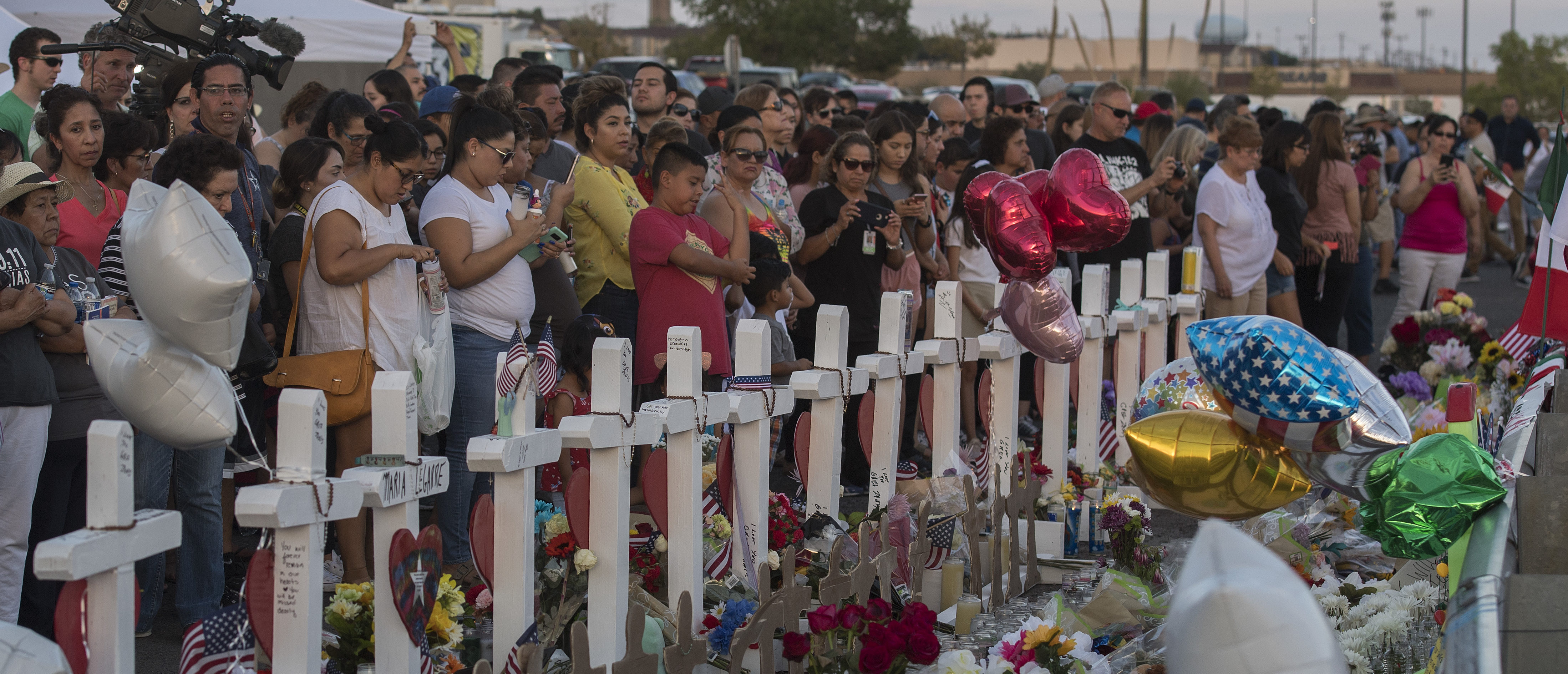 People pay their respects at a makeshift memorial for victims of Walmart shooting that left a total of 22 people dead at the Cielo Vista Mall WalMart in El Paso, Texas, on Aug. 5, 2019. (MARK RALSTON/AFP/Getty Images)