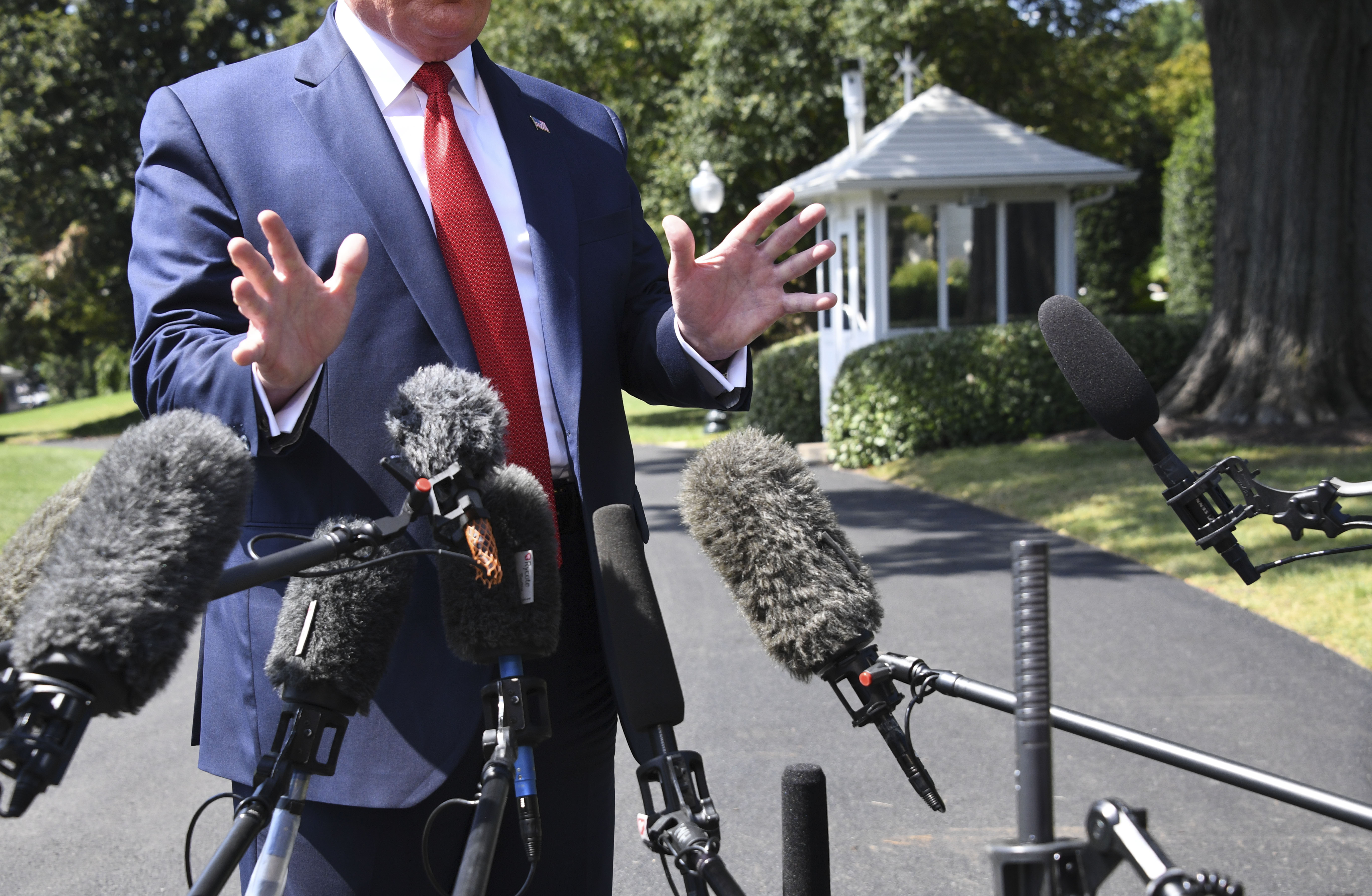 US President Donald Trump speaks to the media as he departs the White House in Washington, DC, on August 21, 2019. (Photo by Jim WATSON / AFP) (Photo credit should read JIM WATSON/AFP/Getty Images)