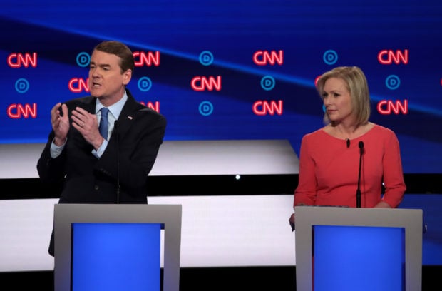 DETROIT, MICHIGAN - JULY 31: Democratic presidential candidate Sen. Michael Bennet (D-CO) speaks while Sen. Kirsten Gillibrand (D-NY) listens during the Democratic Presidential Debate at the Fox Theatre July 31, 2019 in Detroit, Michigan. 20 Democratic presidential candidates were split into two groups of 10 to take part in the debate sponsored by CNN held over two nights at Detroit’s Fox Theatre. (Photo by Scott Olson/Getty Images)