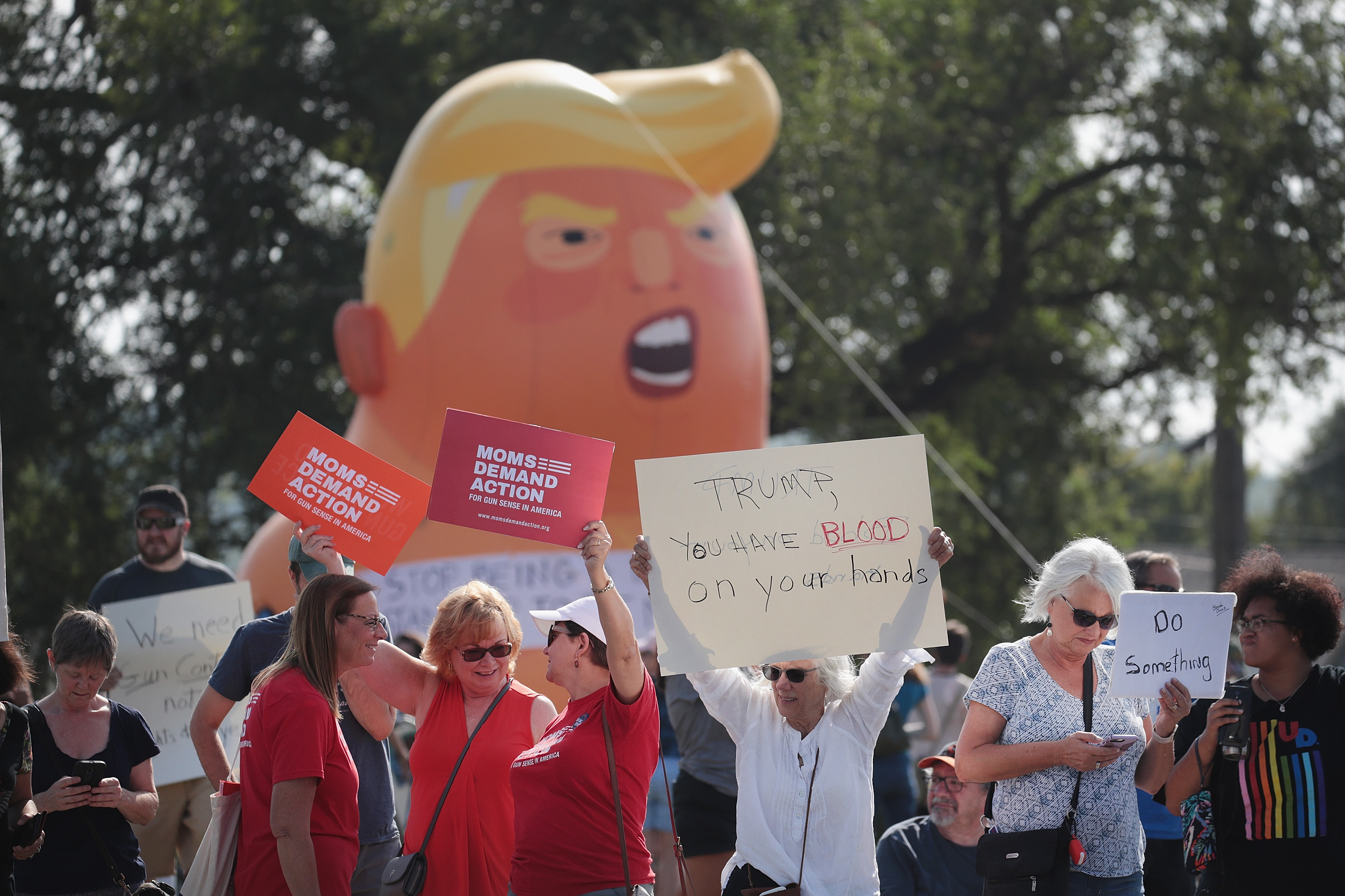Demonstrators line the street near Miami Valley Hospital in anticipation of a visit from President Donald Trump on August 07, 2019 in Dayton, Ohio. (Scott Olson/Getty Images)