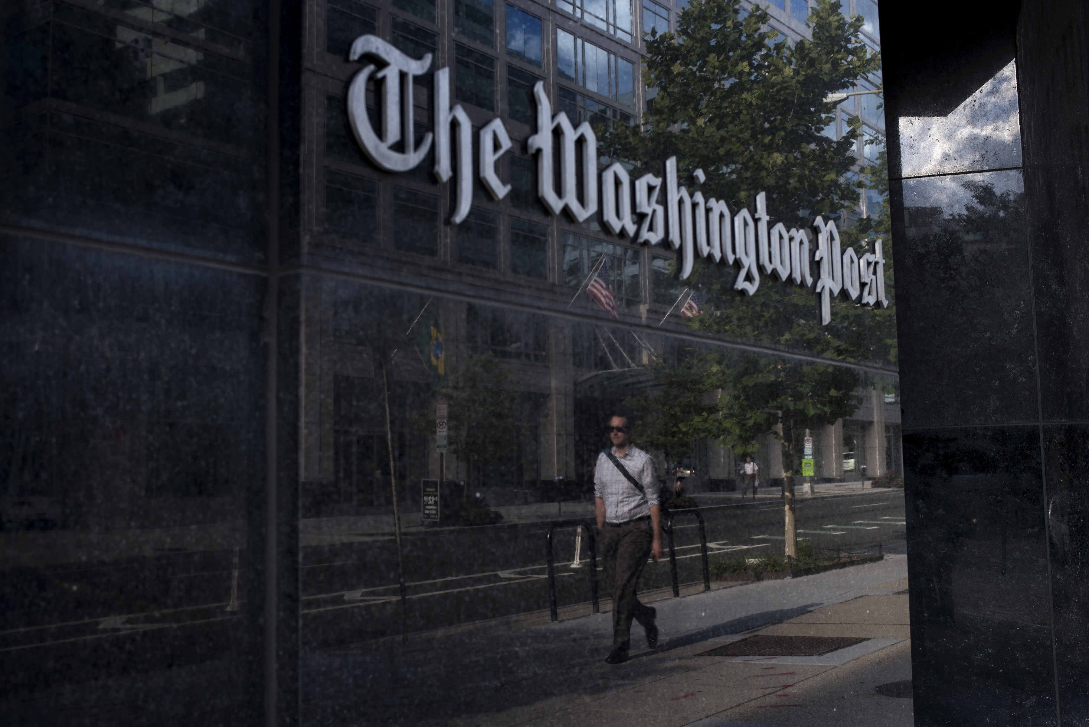 A man walks past The Washington Post on August 5, 2013 in Washington, DC after it was announced that Amazon.com founder and CEO Jeff Bezos had agreed to purchase the Post for USD 250 million. (BRENDAN SMIALOWSKI/AFP/Getty Images)