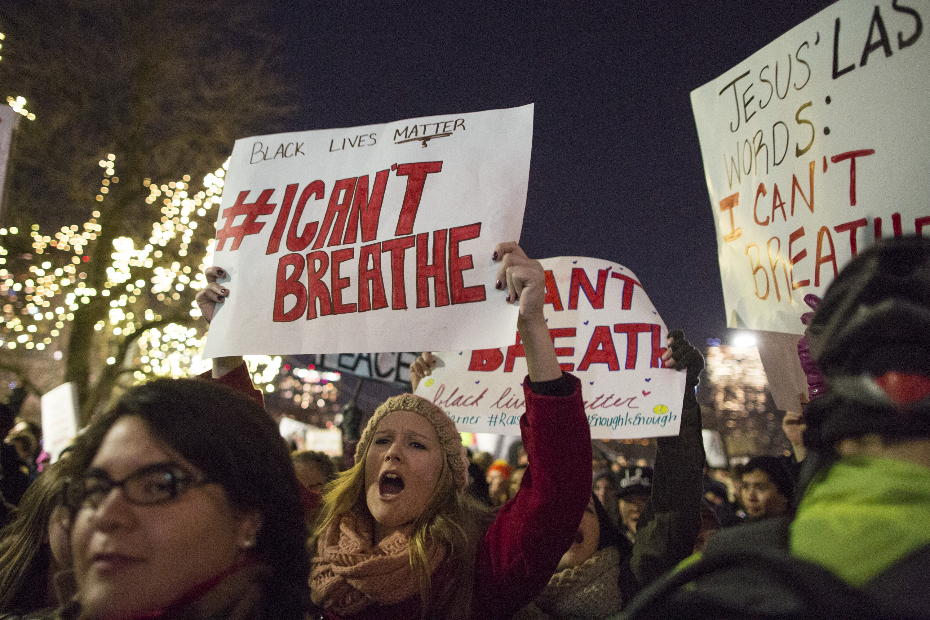 BOSTON, MA - DECEMBER 4: Protesters march while chanting and holding signs during a protest against the decision by a Staten Island grand jury not to indict a police officer who used a chokehold in the death of Eric Garner in July, on December 4, 2014 in Boston, Massachusetts. The grand jury declined to indict New York City Police Officer Daniel Pantaleo in Garner's death. (Photo by Scott Eisen/Getty Images)