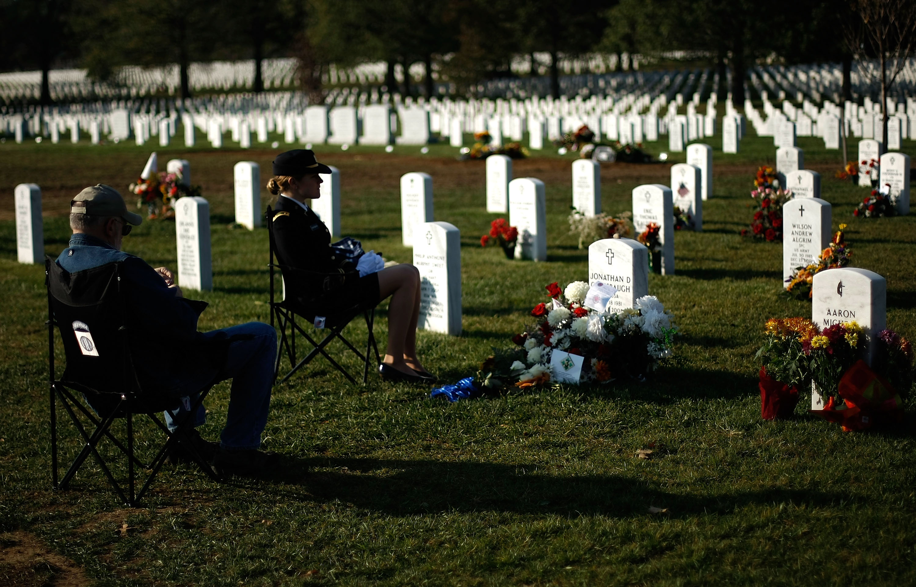 2nd Lieutenant Jenna Grassbaugh (R) and Mark Grassbaugh (L) , visit the gravesite of Captain Jonathan Grassbaugh, husband and son, who was killed in Iraq, at Arlington National Cemetery November 11, 2007 in Arlington, Virginia. Family and friends of U.S. service members across the country remembered the nation's military personnel today on Veterans Day. (Photo by Win McNamee/Getty Images)