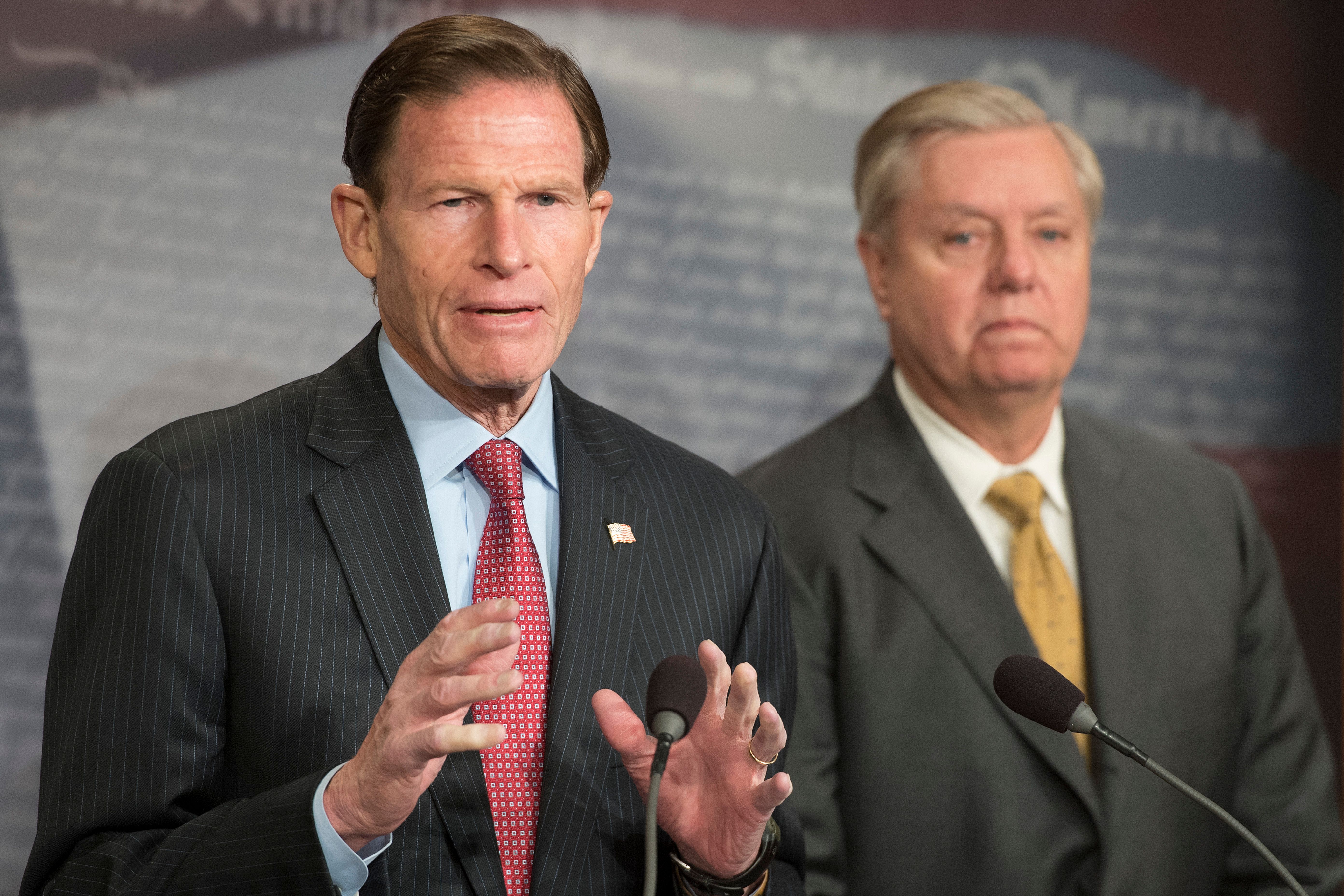 US Senator Lindsey Graham (R), R-South Carolina, and US Senator Richard Blumenthal (L), D-Connecticut, explain Extreme Risk Protection Orders on Capitol Hill in Washington, DC, on March 8, 2018. (JIM WATSON/AFP/Getty Images)