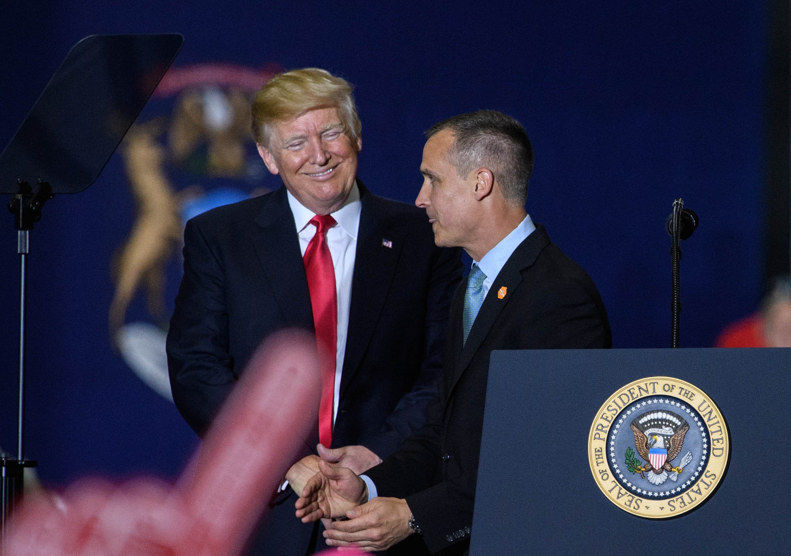 Former Trump Campaign manager Corey Lewandowski speaks as US President Donald Trump looks on during a rally at Total Sports Park in Washington, Michigan on April 28, 2018. (Photo by MANDEL NGAN / AFP) (Photo credit should read MANDEL NGAN/AFP/Getty Images)