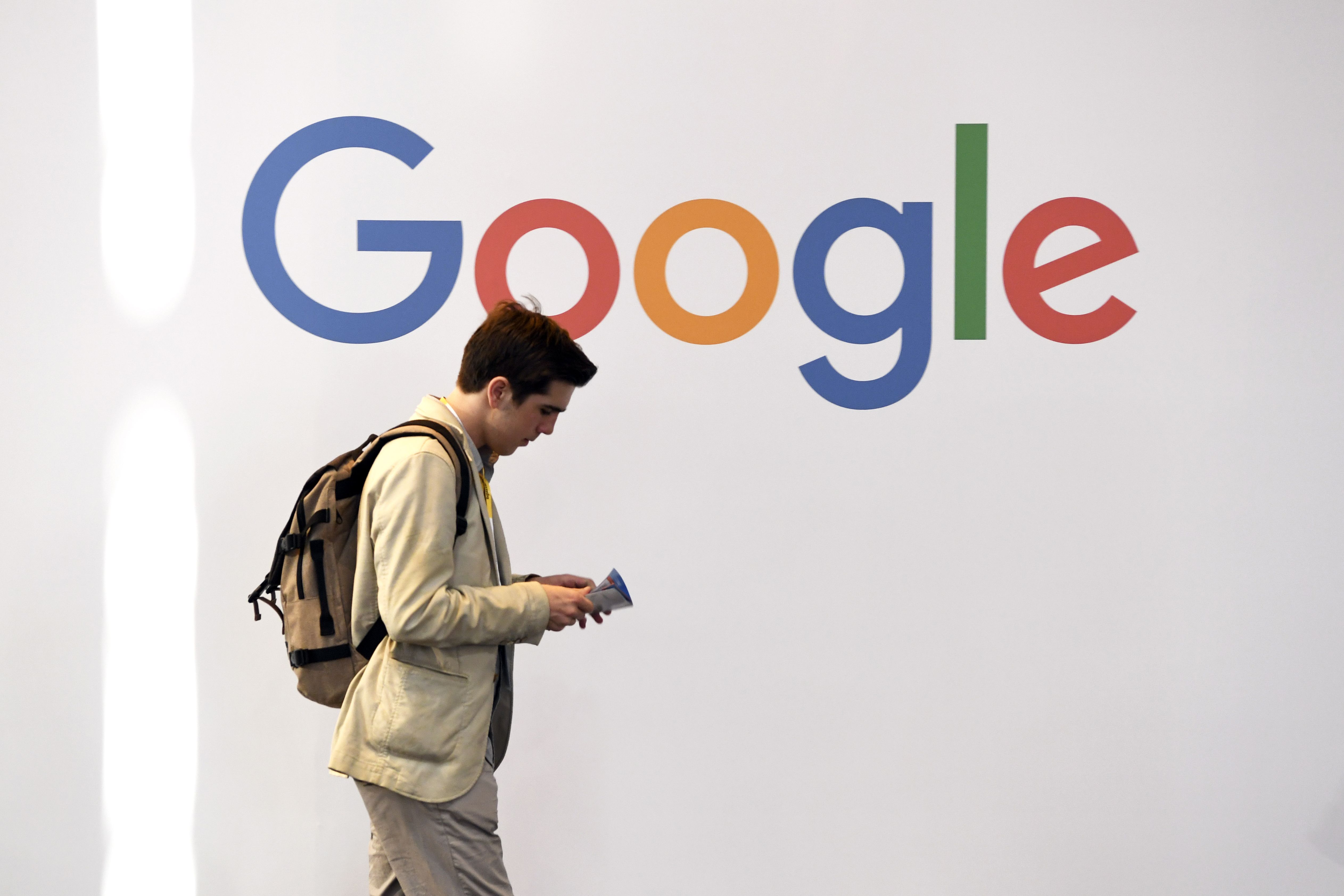 A man walks past the logo of the US multinational technology company Google during the VivaTech trade fair ( Viva Technology), on May 24, 2018 in Paris. (Photo by ALAIN JOCARD / AFP / Getty)