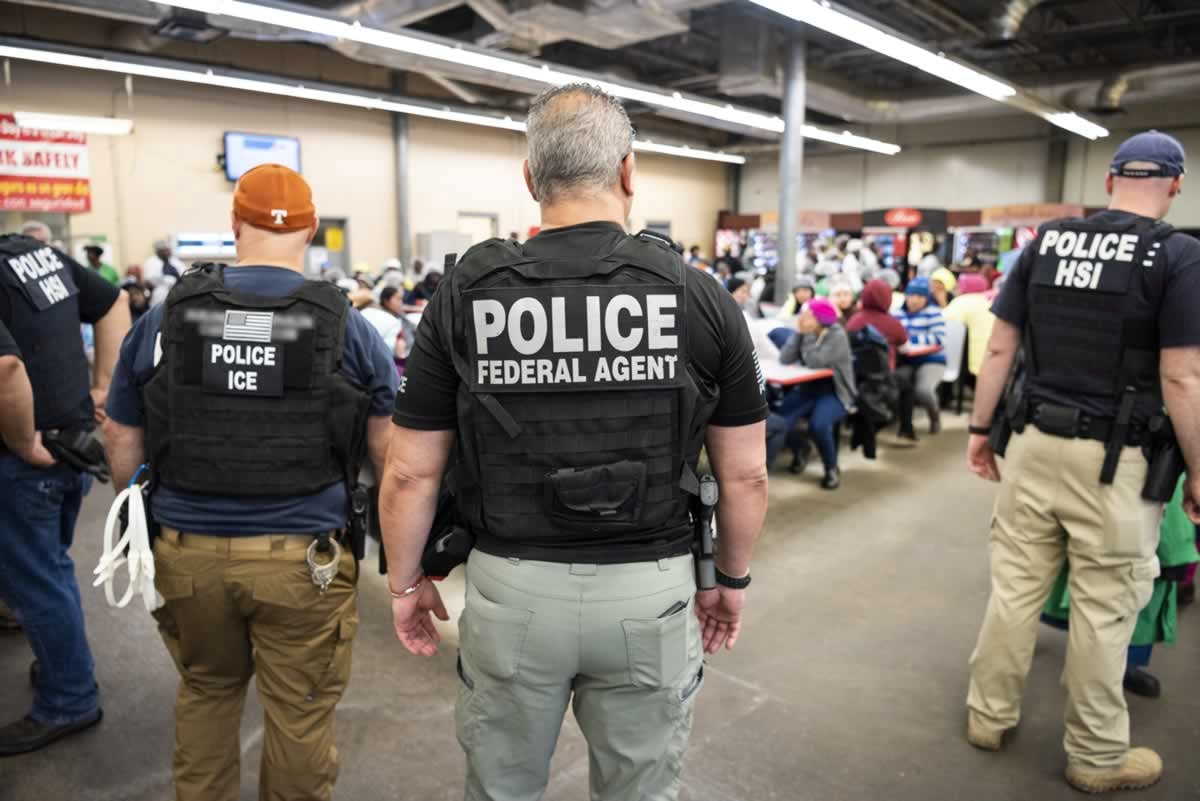 ICE officers oversee a group of detained undocumented workers during last week's raids. (Reuters/Handout)
