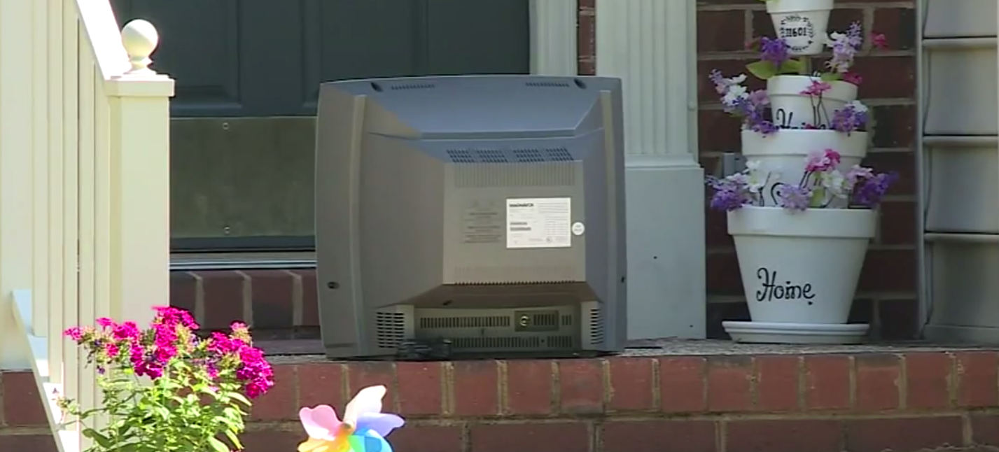 Man wearing TV on head caught on camera leaving old TVs on Virginia front porches. Photo Youtube Screenshot courtesy of KAMC.