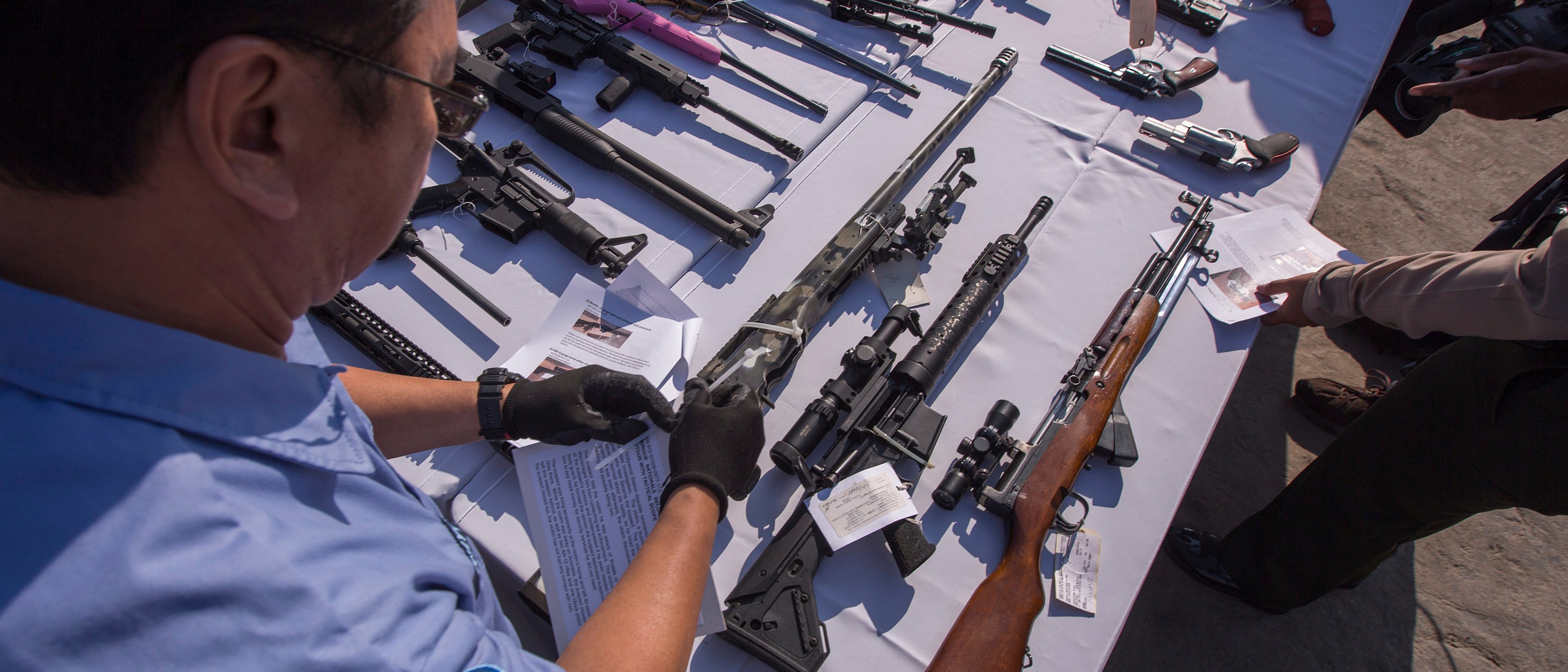 Deputies handle some of approximately 3,500 confiscated guns to be melted down at Gerdau Steel Mill on July 19, 2018 in Rancho Cucamonga, California. (Photo by David McNew/Getty Images)