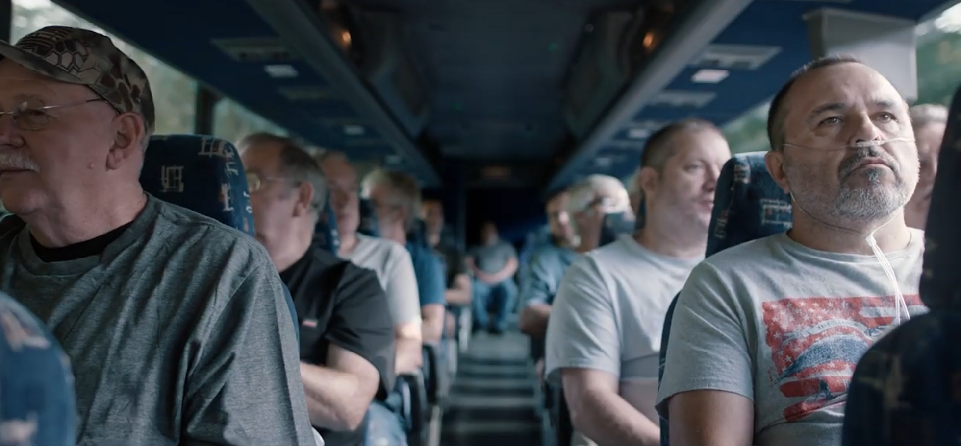 Coal miners reenact a bus ride to visit with Kentucky Republican Sen. Mitch McConnell. Opening scene from an attack ad by Democratic candidate Amy McGrath. YouTube screenshot.