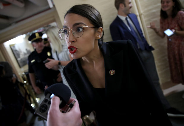 Rep. Alexandria Ocasio-Cortez (D-NY) answers questions while entering a House Democratic caucus meeting where Speaker Nancy Pelosi announced formal impeachment proceedings against President Donald Trump on September 24, 2019. (Win McNamee/Getty Images)