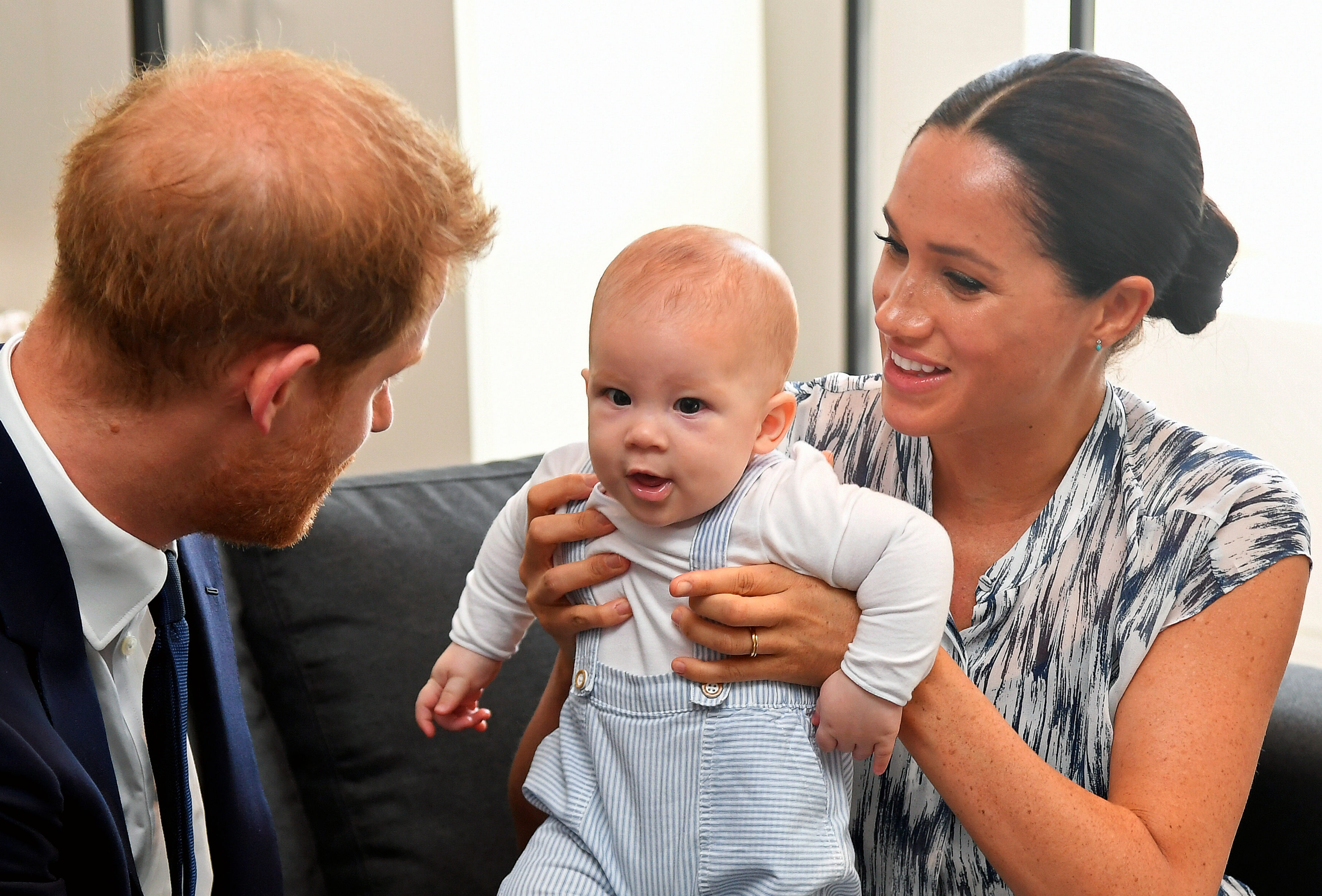 Prince Harry, Duke of Sussex and Meghan, Duchess of Sussex tend to their baby son Archie Mountbatten-Windsor at a meeting with Archbishop Desmond Tutu at the Desmond & Leah Tutu Legacy Foundation during their royal tour of South Africa on September 25, 2019 in Cape Town, South Africa. (Photo by Toby Melville - Pool/Getty Images)