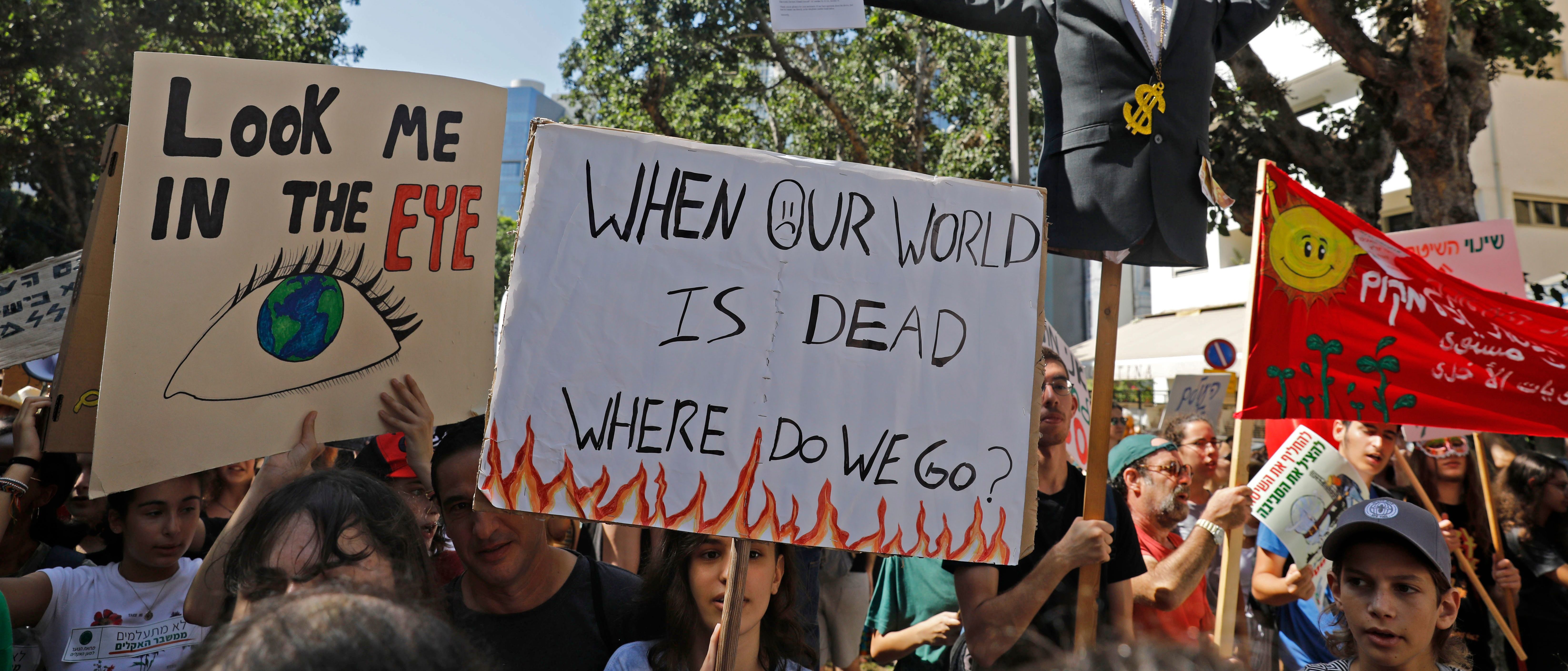Israeli activists and demonstrators hold placards as they take part in a Global Climate Strike in the Israeli coastal city of Tel Aviv on September 27, 2019 against inaction on climate change. (AHMAD GHARABLI/AFP/Getty Images)