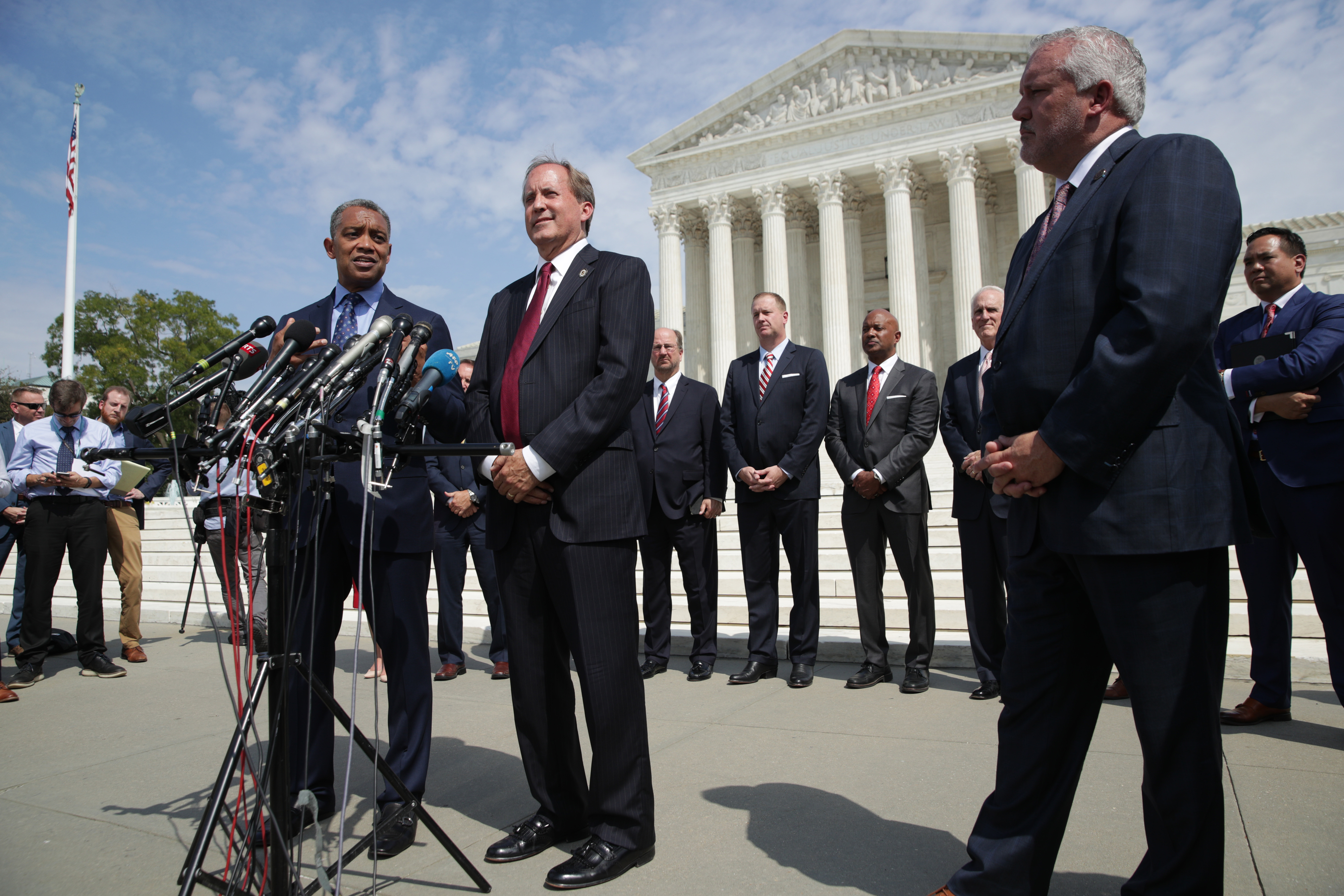 Washington, DC Attorney General Karl Racine (L) speaks as Arkansas Attorney General Leslie Rutledge and Texas Attorney General Ken Paxton listens during a news conference in front of the U.S. Supreme Court September 9, 2019 in Washington, DC. (Photo by Alex Wong/Getty Images)
