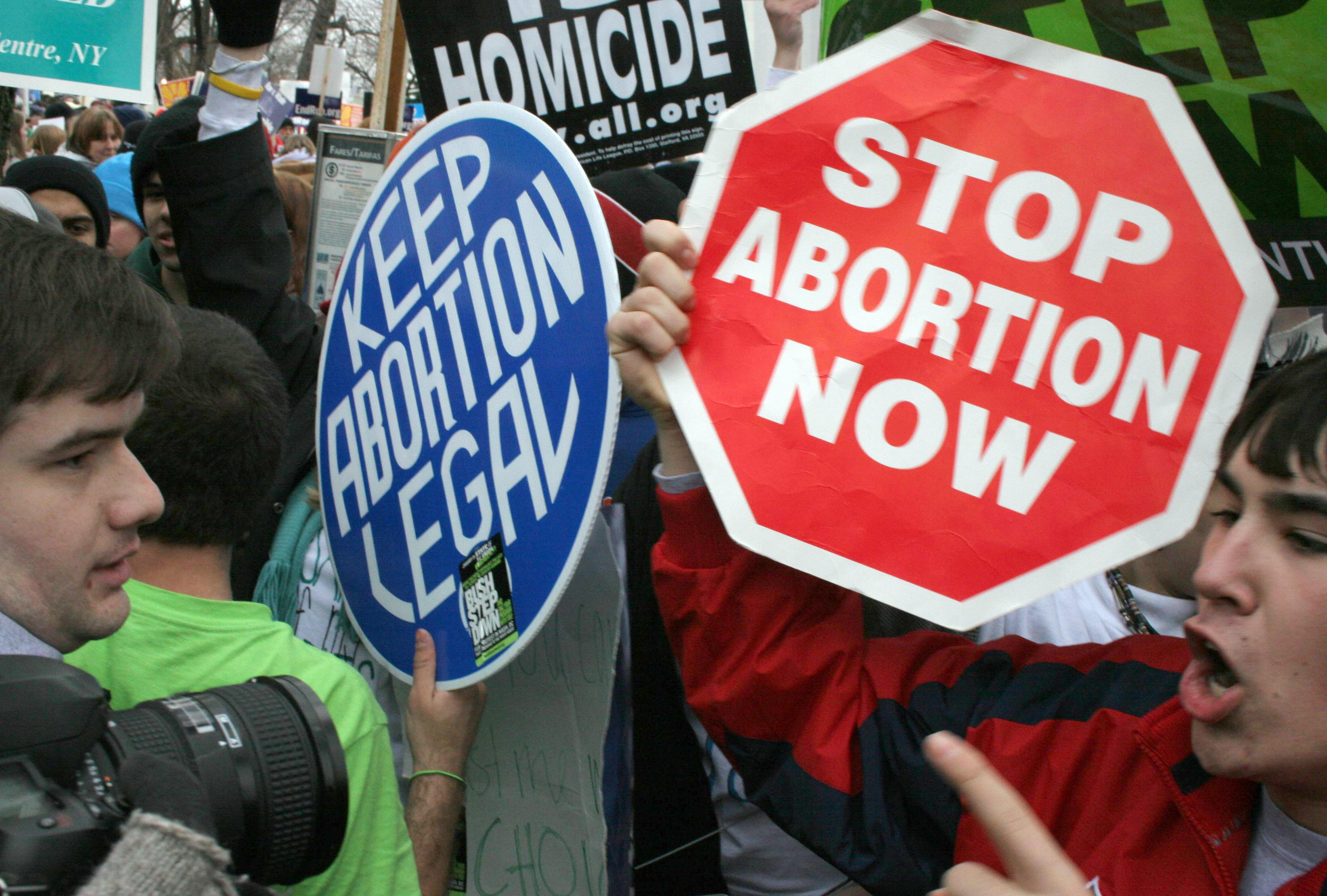 Washington, UNITED STATES: Pro-life demonstrators (R) confront pro-choice counterparts (L) 23 January 2006 in Washington, DC, as tens of thousands of pro-life and pro-choice opponents rally marking the 33rd anniversary of the Supreme Court ruling on abortion. Abortion has been legal in the United States since the Supreme Court's decision in Roe v. Wade on 22 January 1973. AFP PHOTO/Karen BLEIER (Photo credit should read KAREN BLEIER/AFP/Getty Images)