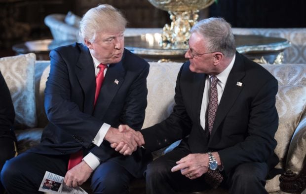 US President Donald Trump shakes hands with Keith Kellogg (R) after announcing him as chief of staff to national security adviser US Army Lieutenant General H.R. McMaster at his Mar-a-Lago resort in Palm Beach, Florida, on February 20, 2017. (NICHOLAS KAMM/AFP/Getty Images)