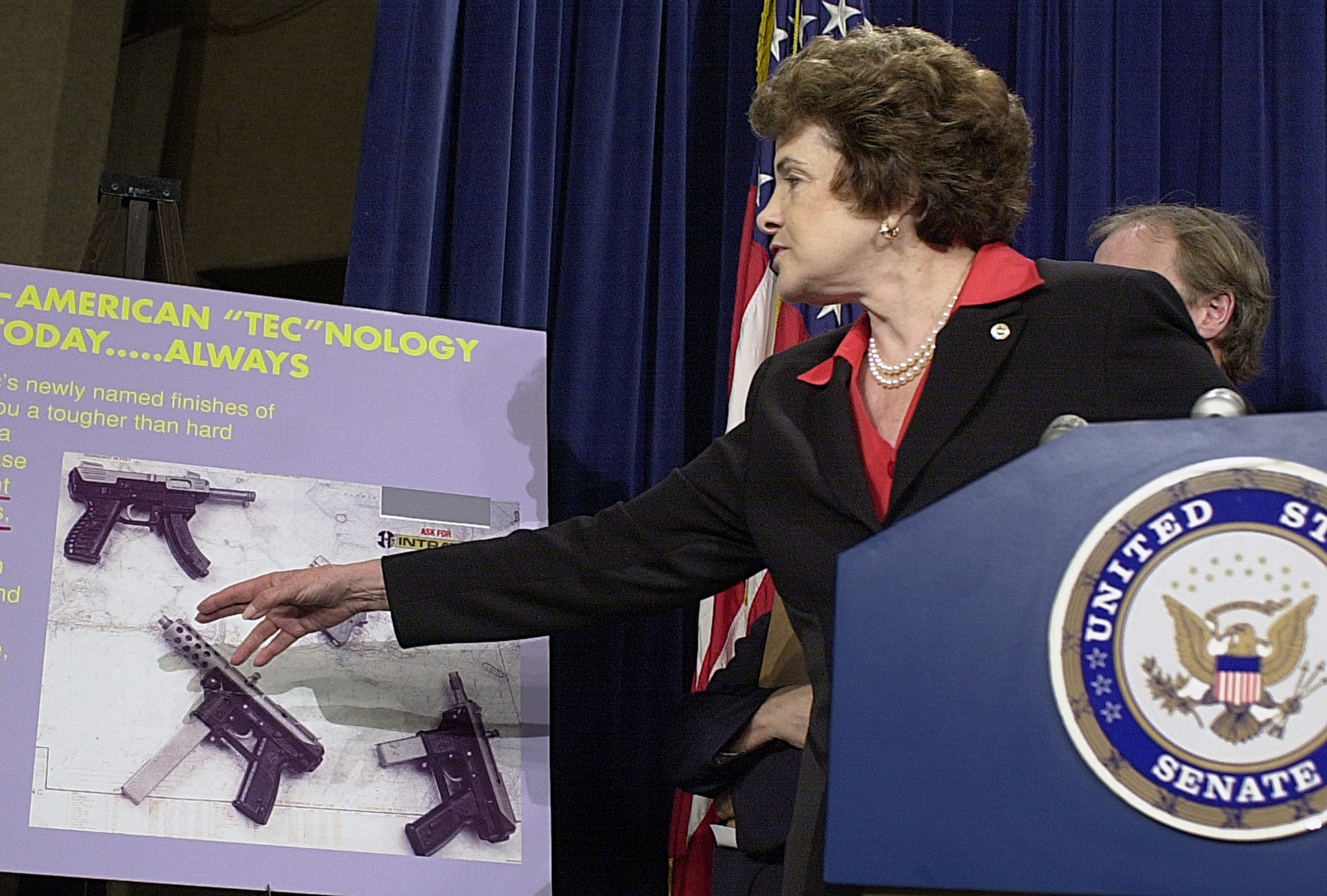 Senator Dianne Feinstein (D-CA) points out an advertisement for an assault weapon during a news briefing, May 8, 2003 on Capitol Hill. REUTERS/Mike Theiler