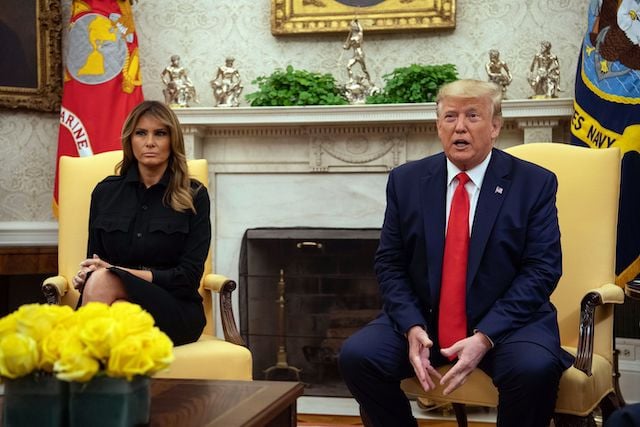 US President Donald Trump, with First Lady Melania Trump, speaks to the press in the Oval Office at the White House in Washington, DC, on September 11, 2019. - Trump on Wednesday announced his administration was considering a ban on flavored vaping products, amid a growing outbreak of severe lung disease in the US that has claimed at least six lives. "It's causing a lot of problems," the president told reporters at the White House, where he was accompanied by Health and Human Services Secretary Alex Azar and acting Food and Drug Administration head Norman Sharpless. (Photo credit: NICHOLAS KAMM/AFP/Getty Images)