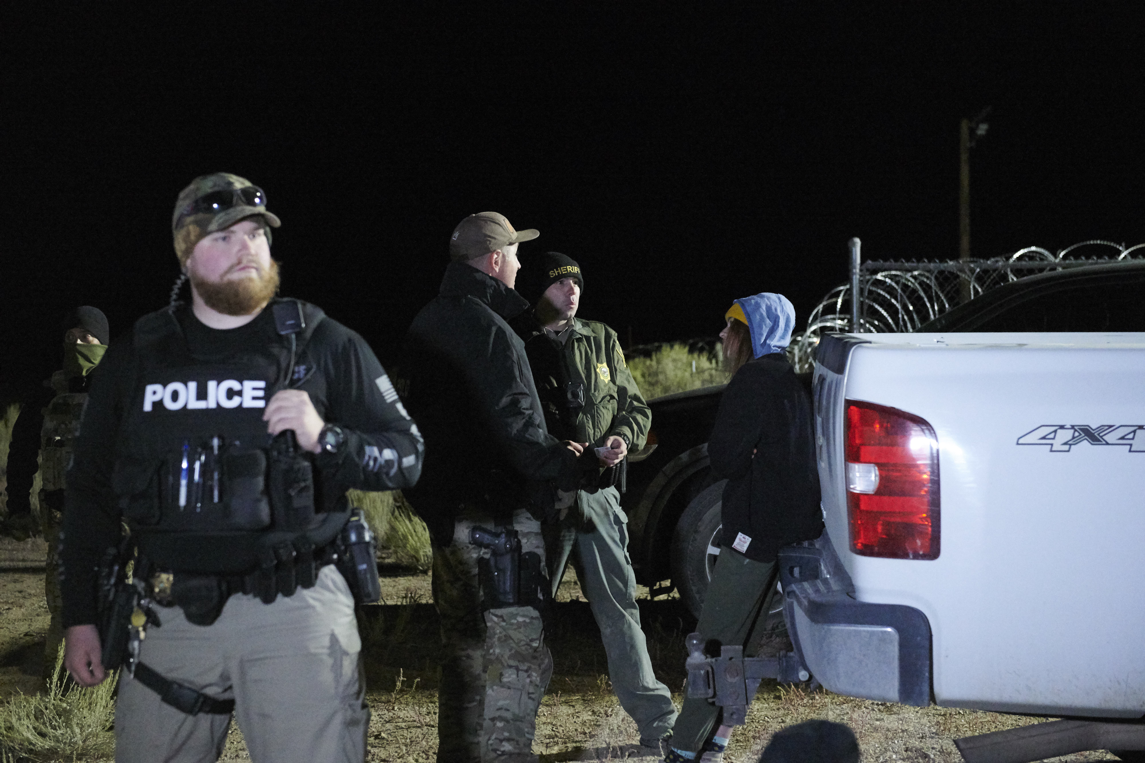 An attendee is detained then released after briefly physically crossing a security line , as attendees gathered to "storm" Area 51, at an entrance to the military facility near Rachel, Nevada on September 20, 2019. (Photo by BRIDGET BENNETT/AFP/Getty Images)