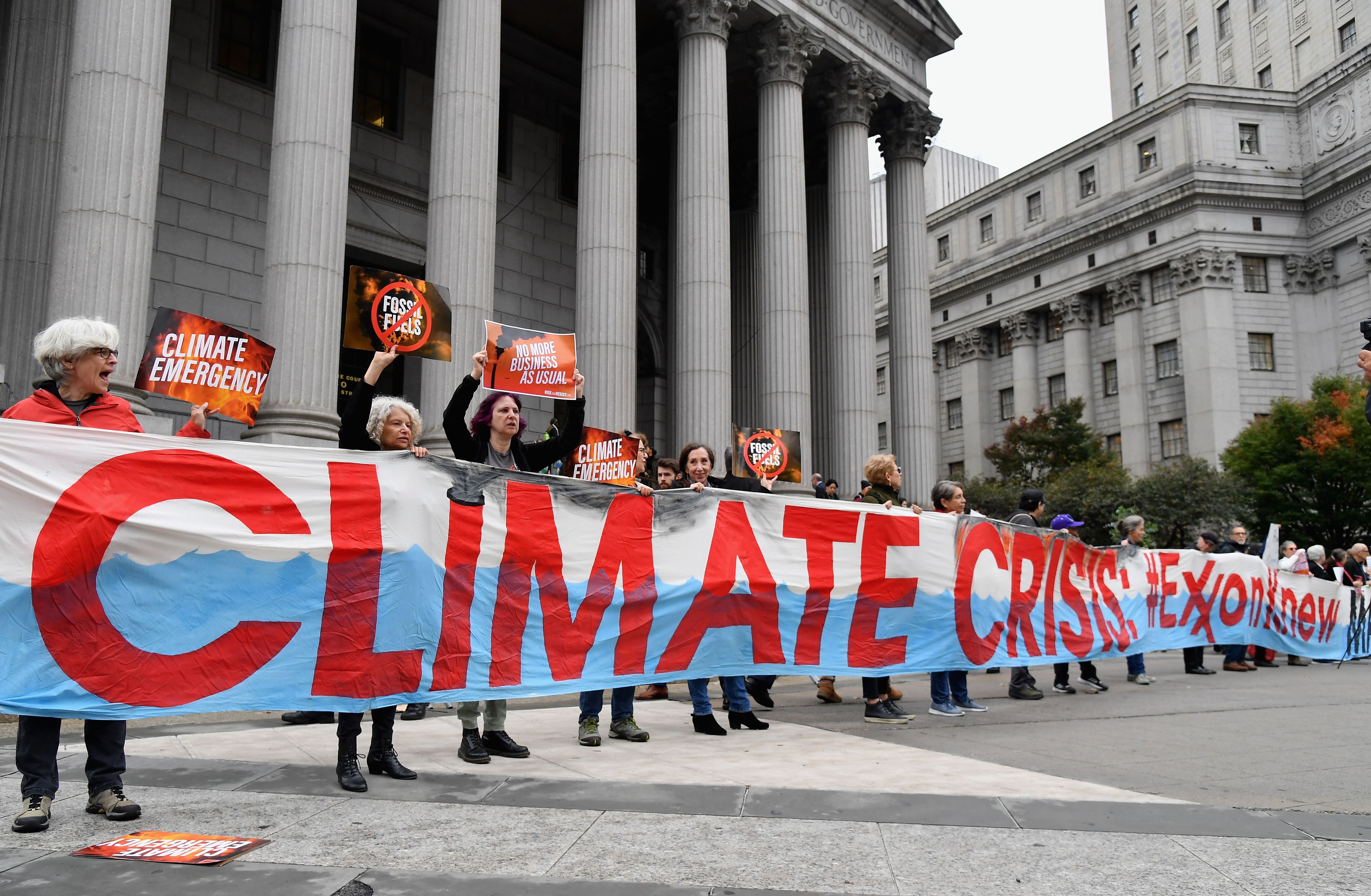Climate activists protest outside the New York State Supreme Court building on October 22, 2019. (Angela Weiss/AFP/Getty Images)