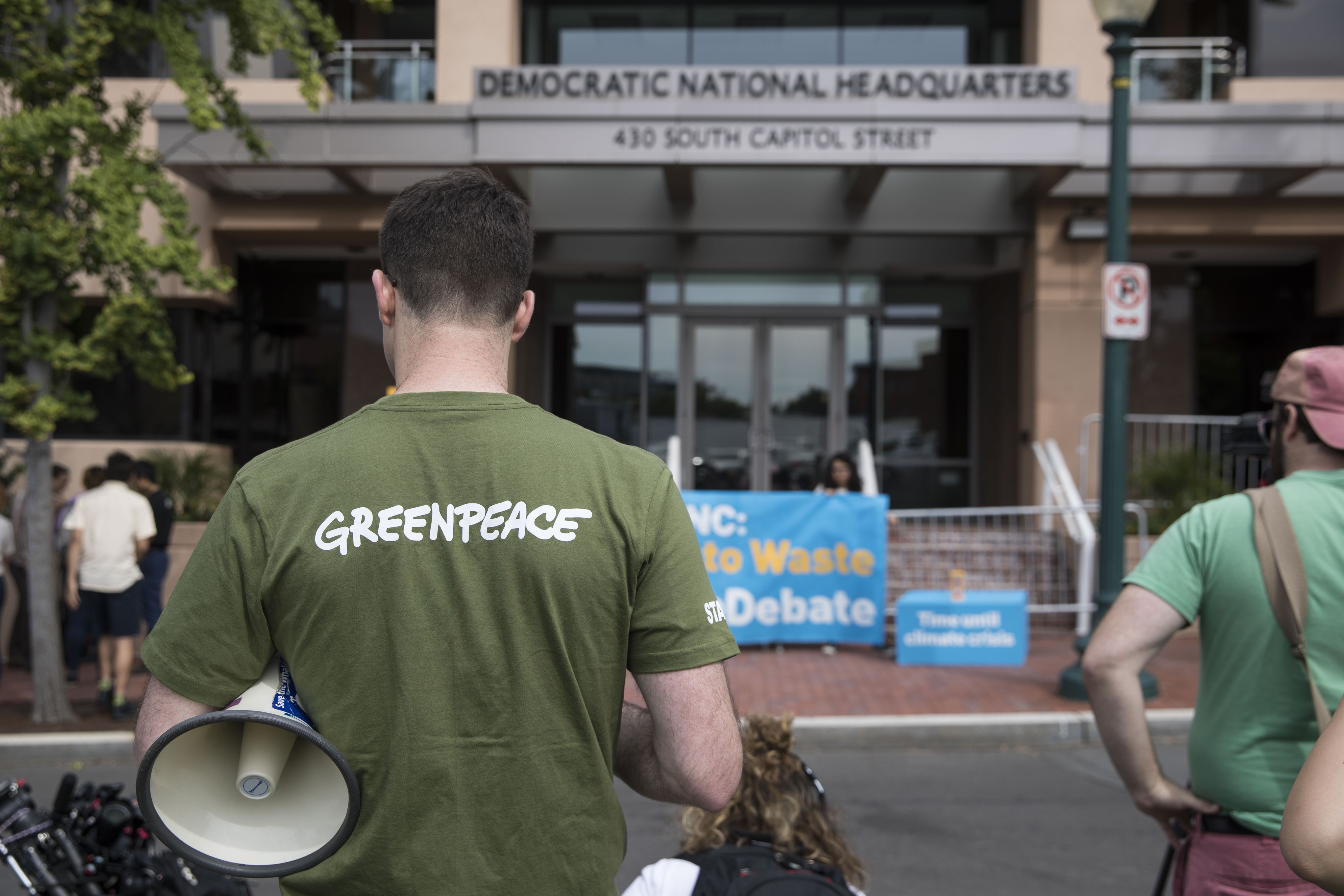WASHINGTON, DC - JUNE 12: Jack Shapiro stands in front of the Democratic National Committee headquarters, during a Greenpeace rally to call for a presidential campaign climate debate on June 12, 2019 in Washington, DC. DNC chairman Tom Perez rejected a request from Democratic presidential candidate Washington Gov. Jay Inslee to host a 2020 presidential debate focused solely on climate change. (Photo by Sarah Silbiger/Getty Images)