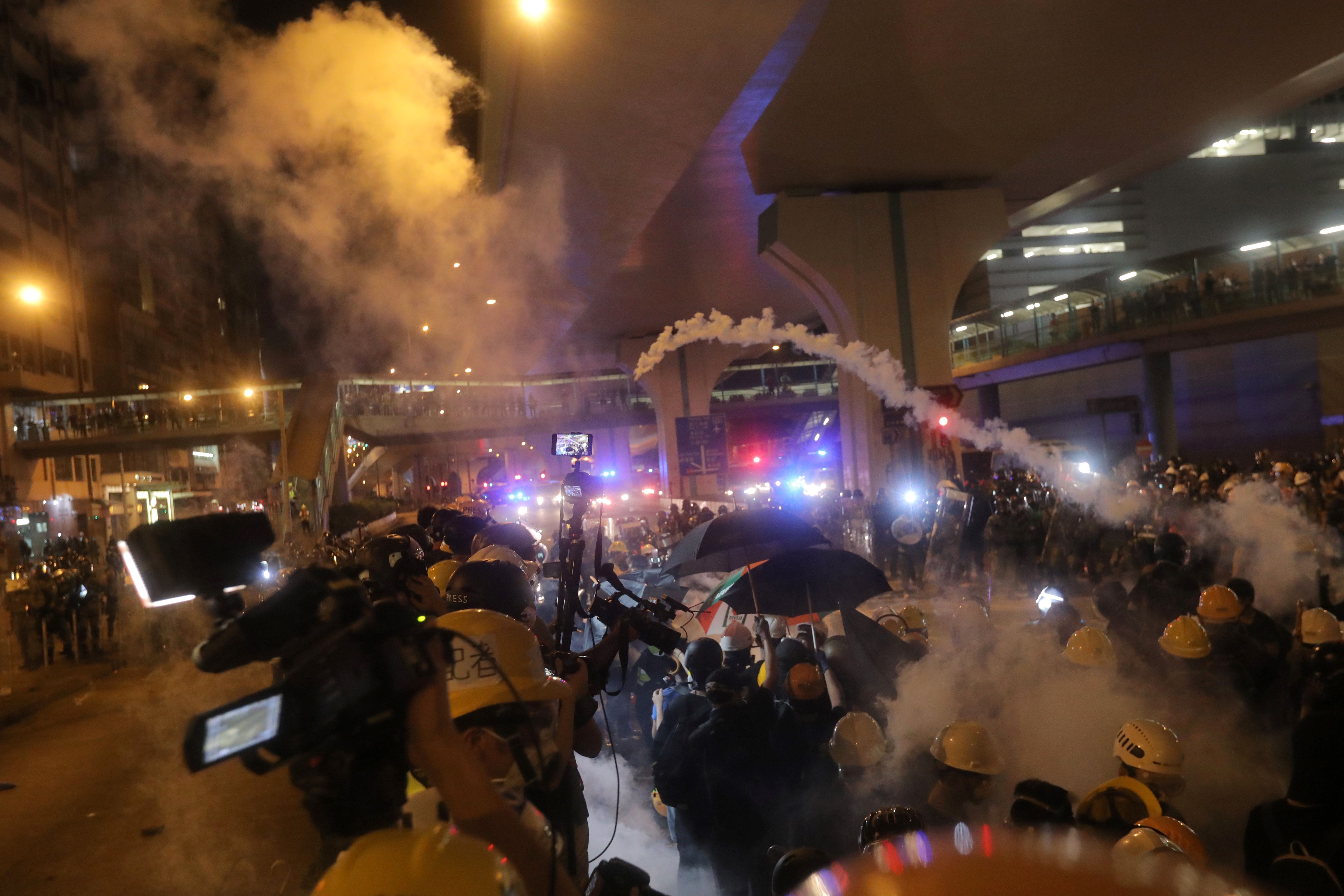 Police fire tear gas to disperse protesters after a march against a controversial extradition bill in Hong Kong on July 21, 2019. - Masked protesters daubed the walls of China's office in Hong Kong with eggs and graffiti on the night of July 21 following another massive rally, focusing anger towards the embodiment of Beijing's rule with no end in sight to the turmoil engulfing the finance hub. (Photo by Vivek Prakash / AFP) (Photo credit should read VIVEK PRAKASH/AFP/Getty Images)