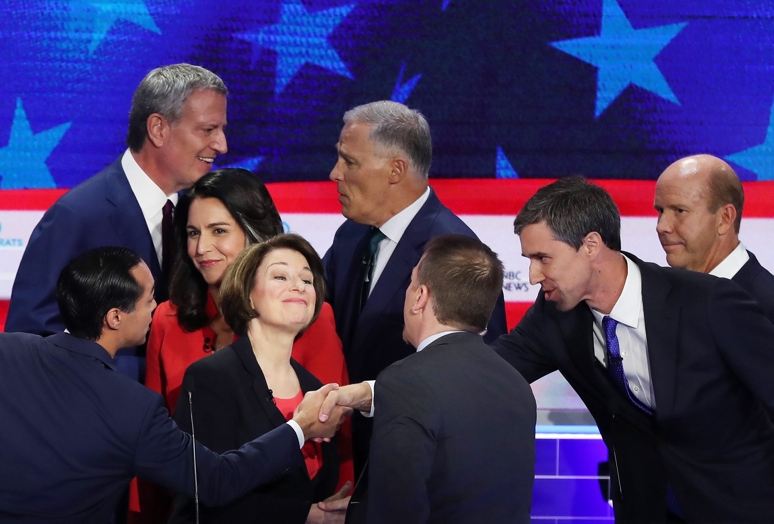 MIAMI, FLORIDA - JUNE 26: Chuck Todd of NBC News greets Sen. Amy Klobuchar (D-MN), former housing secretary Julian Castro, former Texas congressman Beto O'Rourke and other candidates after the first night of the Democratic presidential debate on June 26, 2019 in Miami, Florida. A field of 20 Democratic presidential candidates was split into two groups of 10 for the first debate of the 2020 election, taking place over two nights at Knight Concert Hall of the Adrienne Arsht Center for the Performing Arts of Miami-Dade County, hosted by NBC News, MSNBC, and Telemundo. (Photo by Joe Raedle/Getty Images)