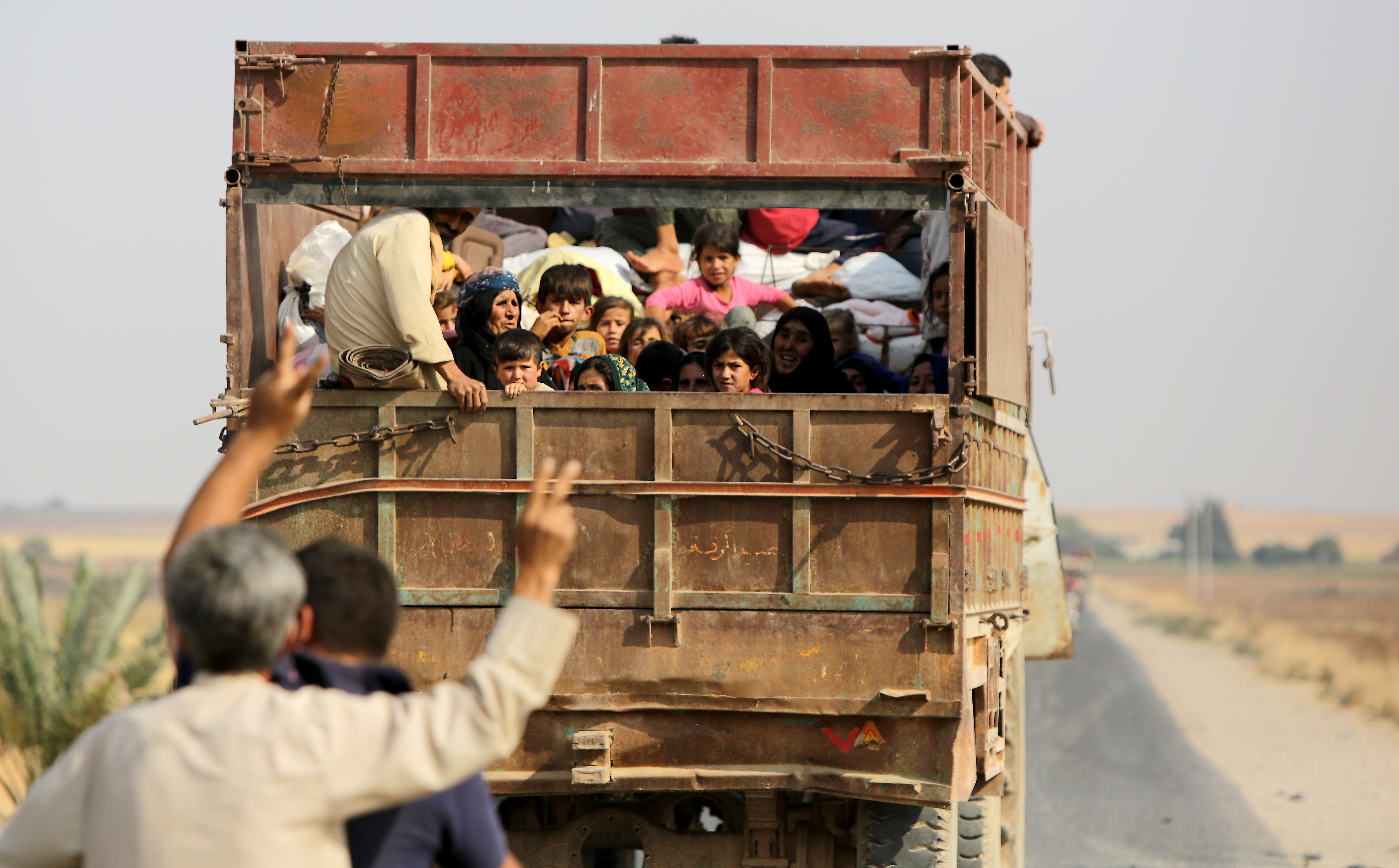 Kurdish Syrian civilians flee the town of Kobani on the Turkish border on October 16, 2019 as Turkey and its allies continue their assault on Kurdish-held border towns in northeastern Syria. (Photo by BAKR ALKASEM/AFP via Getty Images)