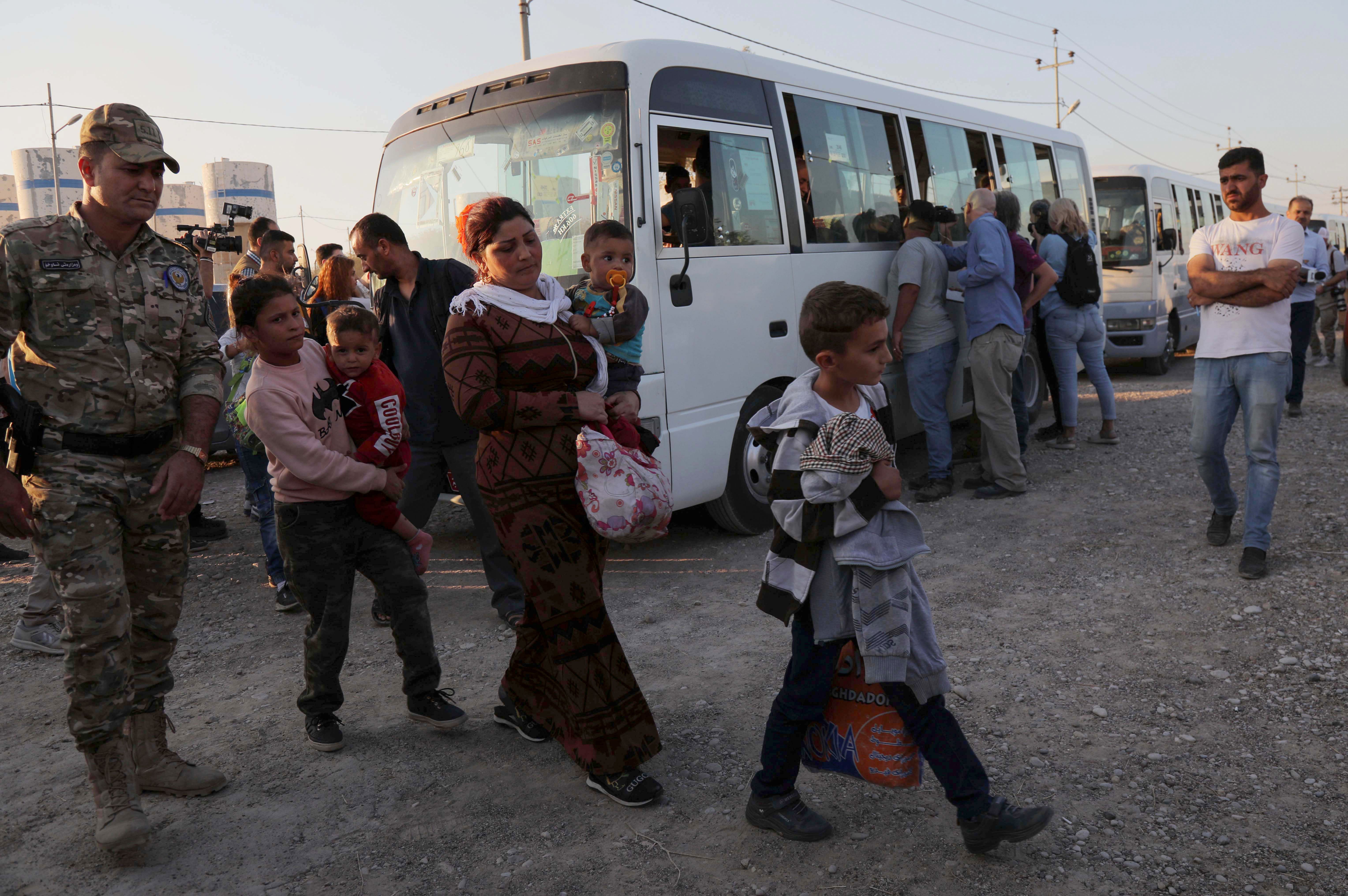 Syrians who have been recently-turned refugees by the Turkish military operation in northeastern Syria are pictured upon arriving at the Bardarash camp, near the Kurdish city of Dohuk, in Iraq's autonomous Kurdish region, on October 16, 2019. (SAFIN HAMED/AFP via Getty Images)