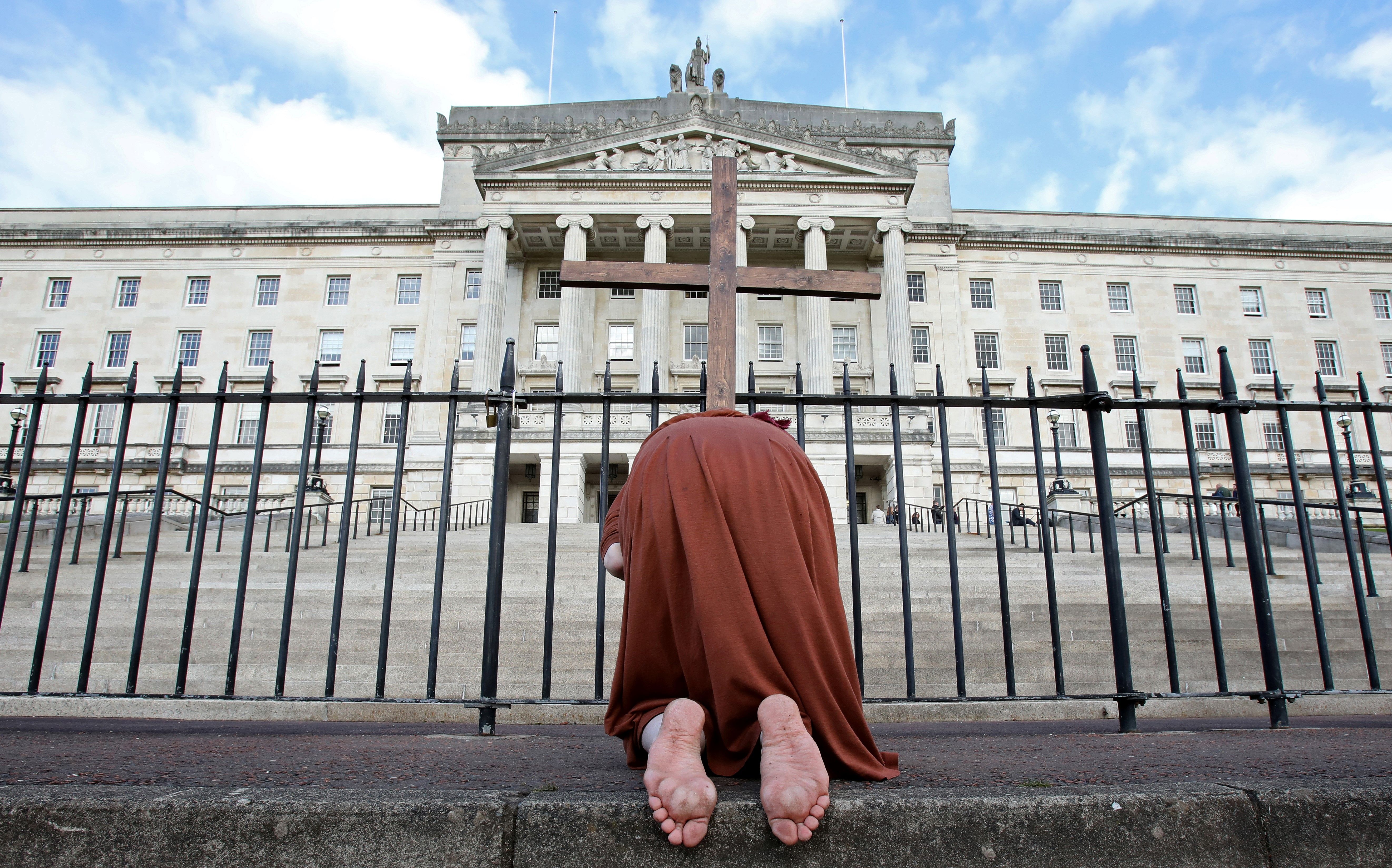 An anti-abortion activist poses for a photograph whilst demonstrating outside of Parliament Buildings, the seat of the Northern Ireland Assembly, on the Stormont Estate in Belfast, Northern Ireland, on October 21, 2019, as a number of lawmakers returned to attend a special sitting. - A group of Northern Irish lawmakers returned to their parliament on Monday in a last-minute protest at the liberalisation of abortion laws, set to come into force after being decided by London for the suspended Belfast executive. The regional government in Belfast collapsed in January 2017 after a scandal over a renewable heating scheme split the power-sharing executive, amid a breakdown in trust. Abortion is currently illegal in the province, except when the mother's life is in danger. (Photo by PAUL FAITH / AFP) (Photo by PAUL FAITH/AFP via Getty Images)