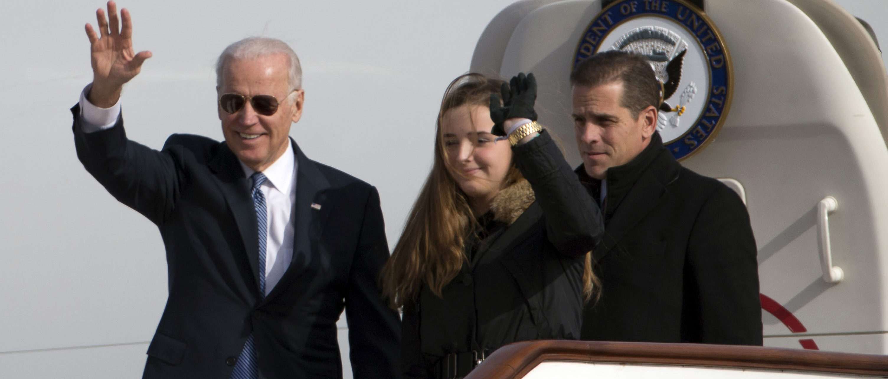 Vice President Joe Biden waves as he walks out of Air Force Two with his granddaughter Finnegan Biden (C) and son Hunter Biden (R) at the airport December 4, 2013 in Beijing, China. Biden is on the first leg of his week-long visit to Asia. (Photo by Ng Han Guan-Pool/Getty Images)