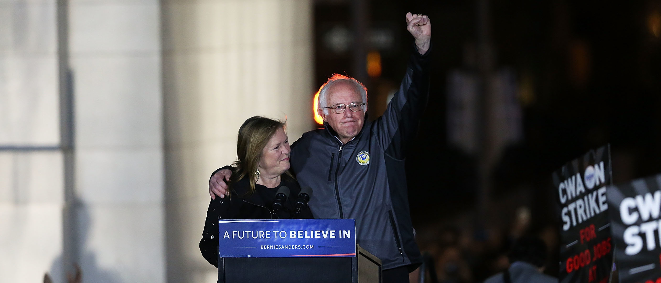 NEW YORK, NEW YORK - APRIL 13: Democratic Presidential candidate Bernie Sanders stands on stage with his wife Jane O'Meara Sanders before speaking to thousands of people at a rally for in New York CityÕs historic Washington Square Park on April 13, 2016 in New York City. While Sanders is still significantly behind Hillary Clinton in the delegate count, he continues to run a spirited campaign that has resonated with young and liberal voters. (Photo by Spencer Platt/Getty Images)